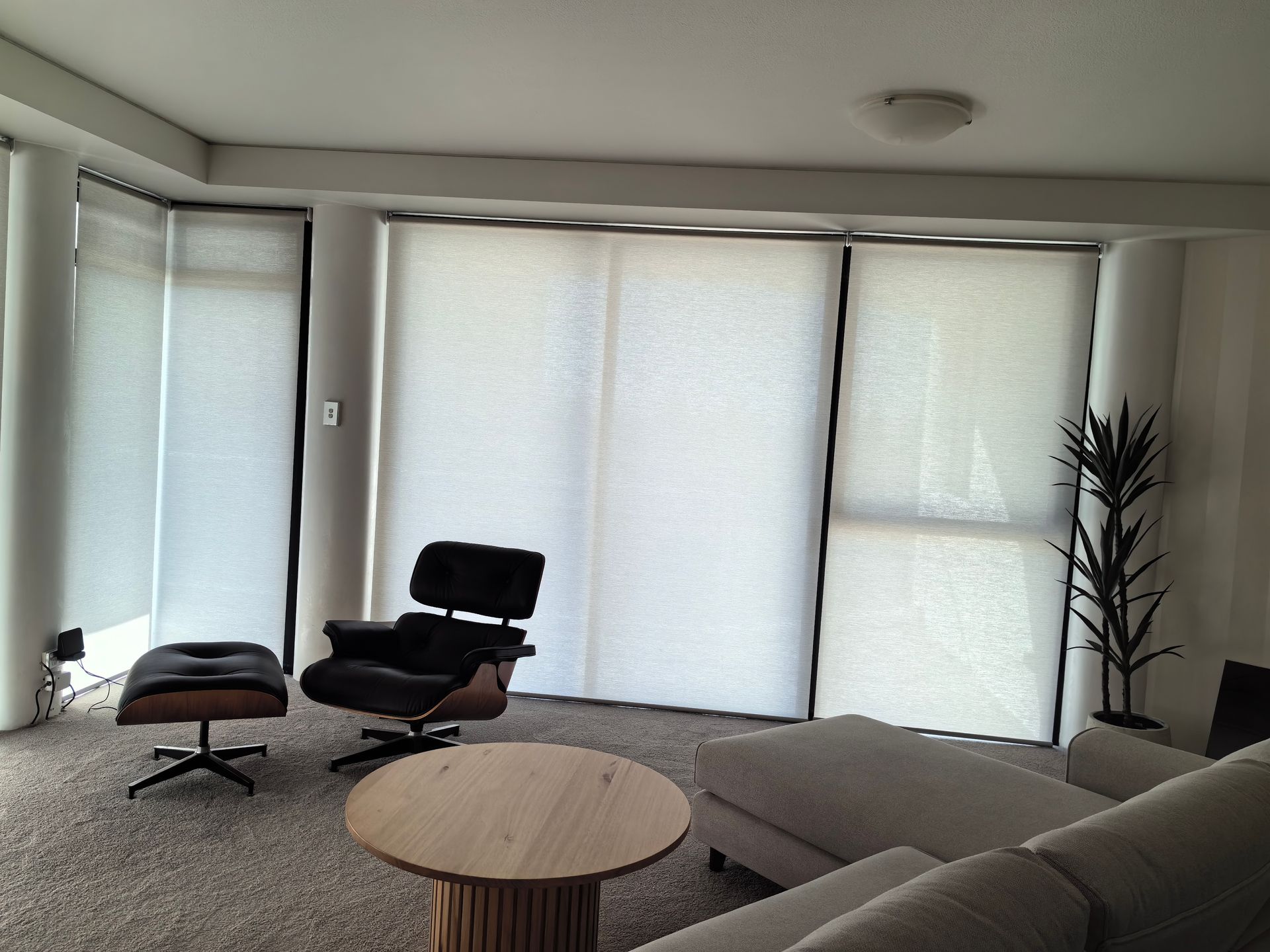 A living room with a couch a chair and a table