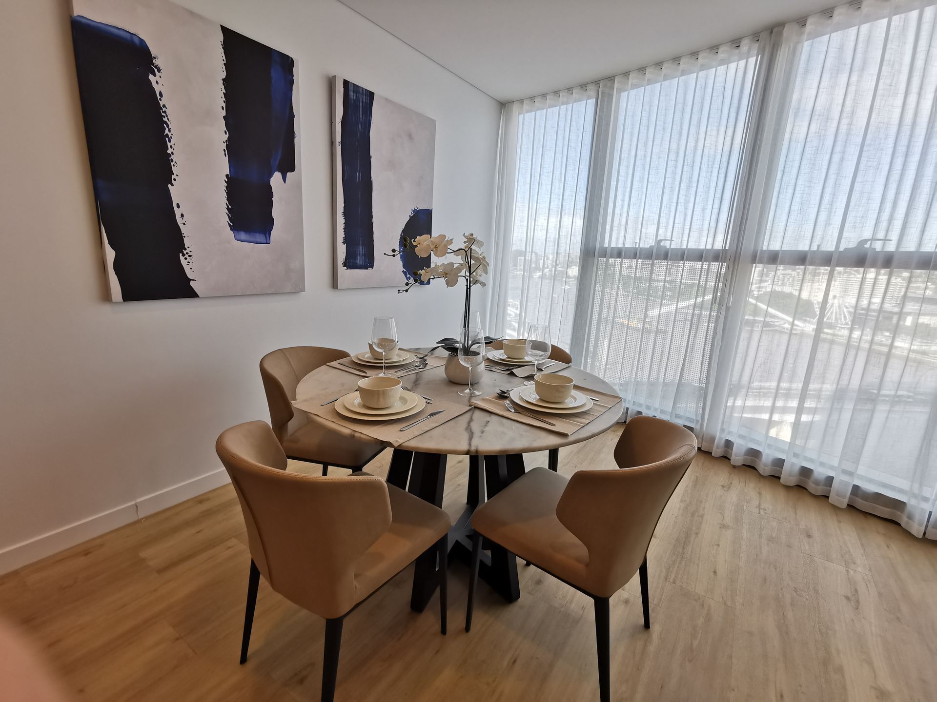 A dining room with a round table and chairs