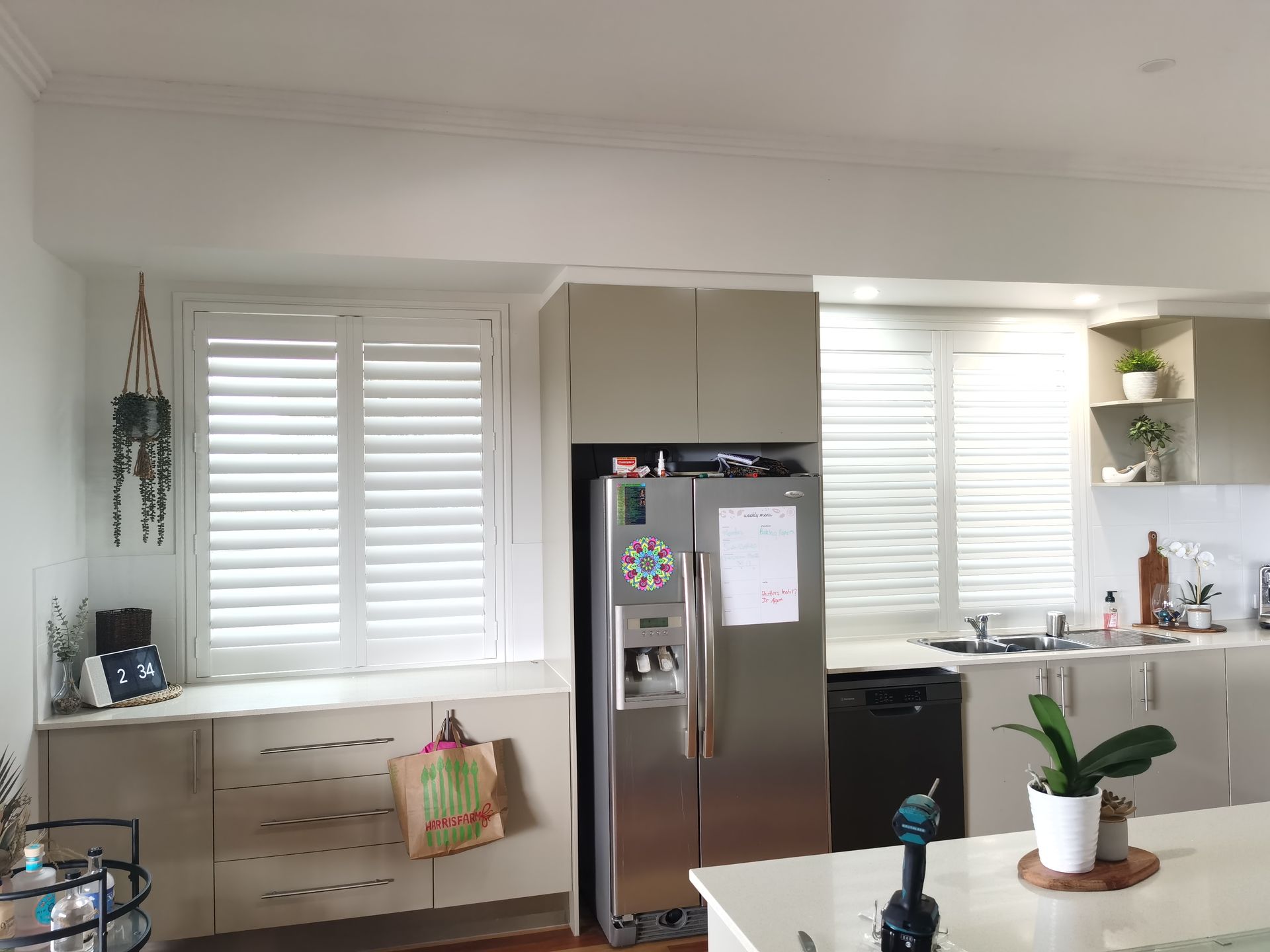 A kitchen with stainless steel appliances and white cabinets.