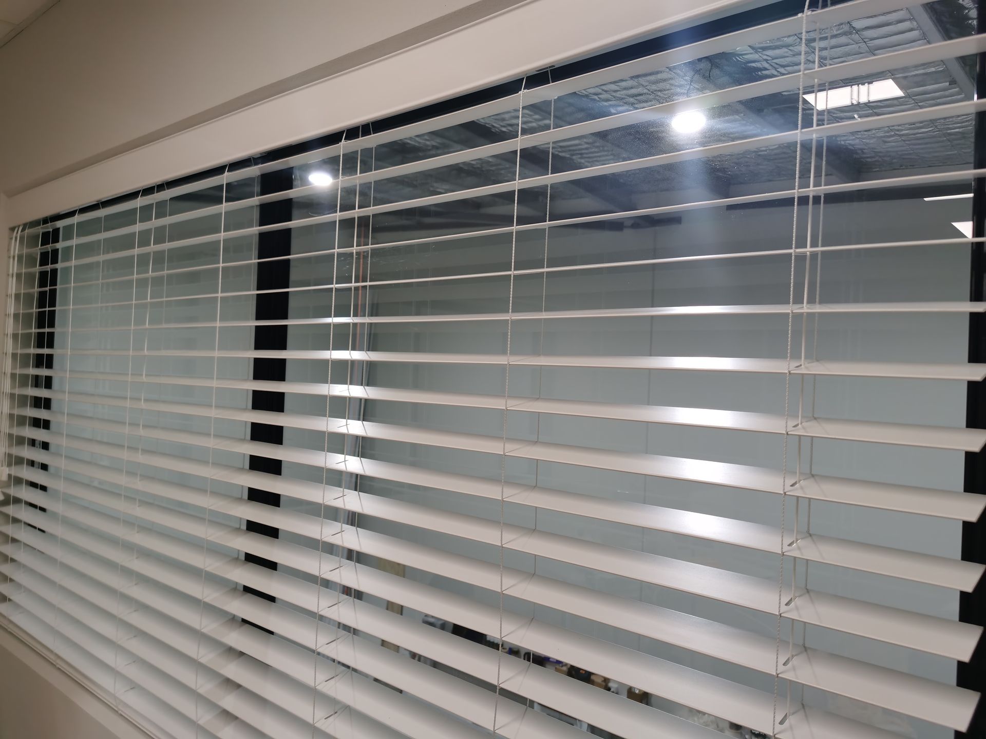 A close up of a window with blinds on it.