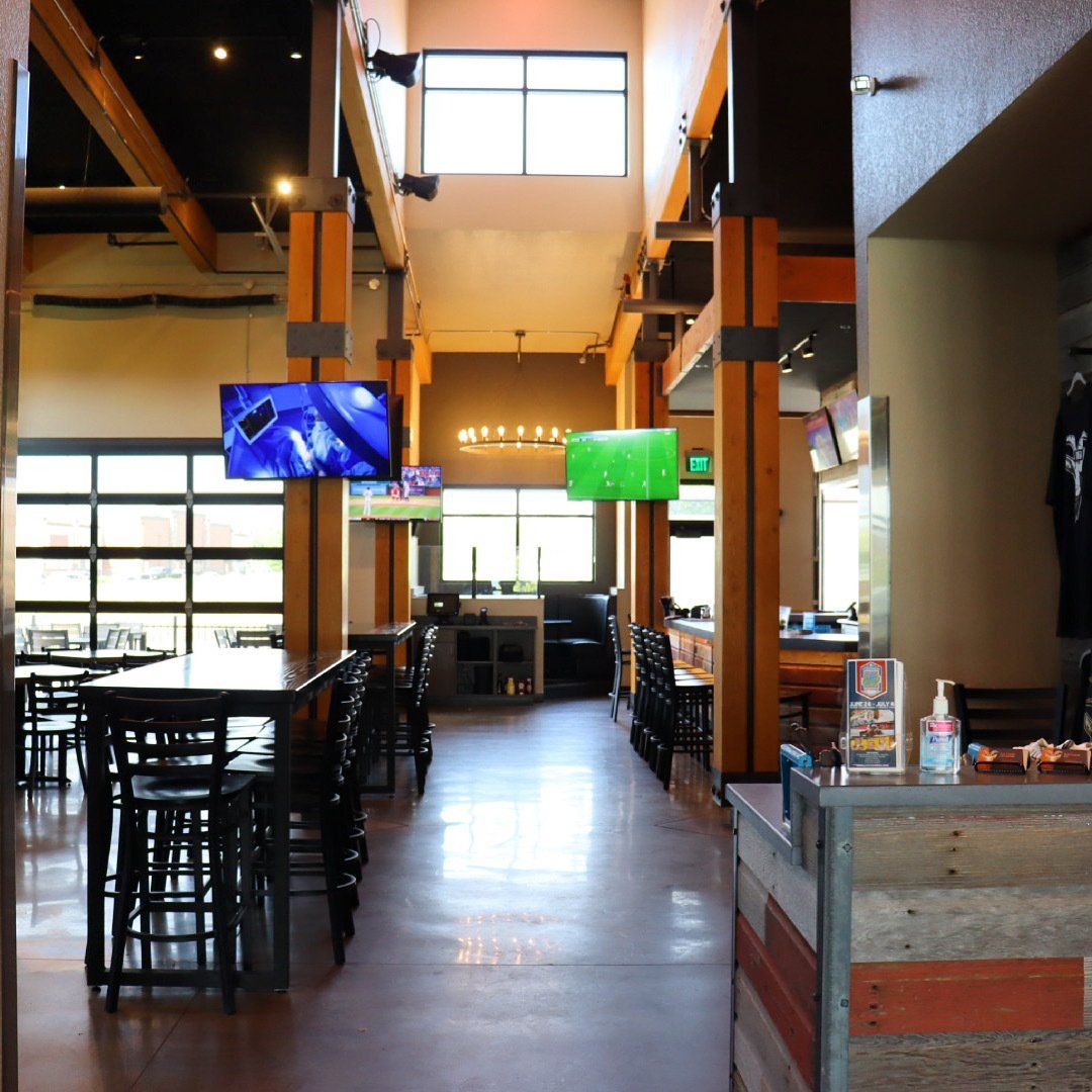 A long hallway in a restaurant with tables and chairs