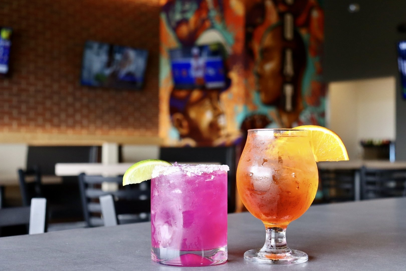Two drinks are sitting on a table in a restaurant.