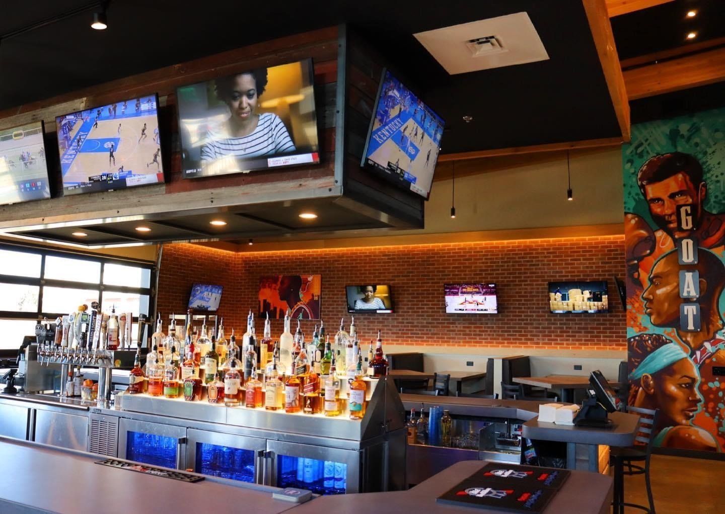 A bar with a lot of bottles of liquor on it