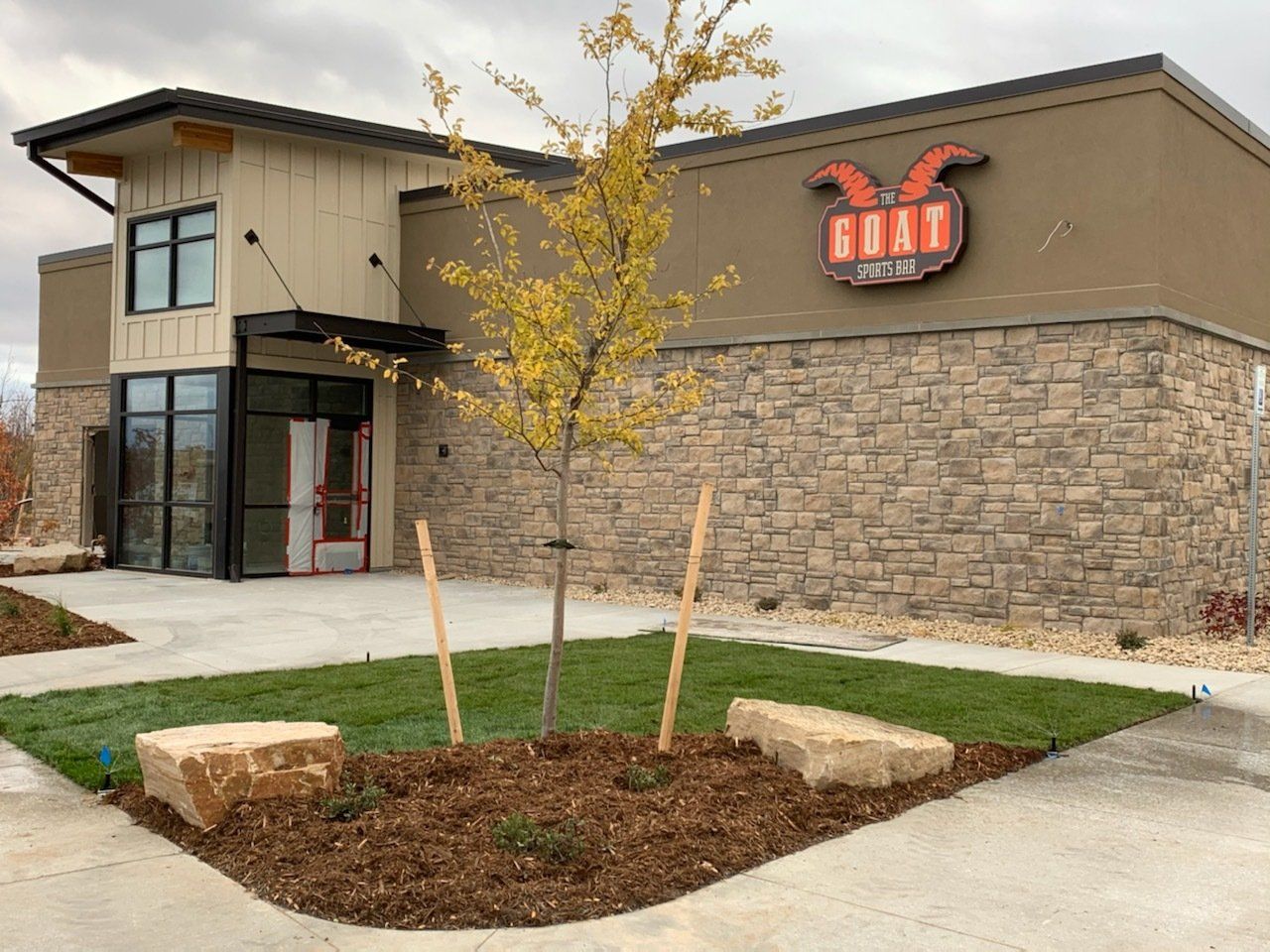 A large building with a tree in front of it.