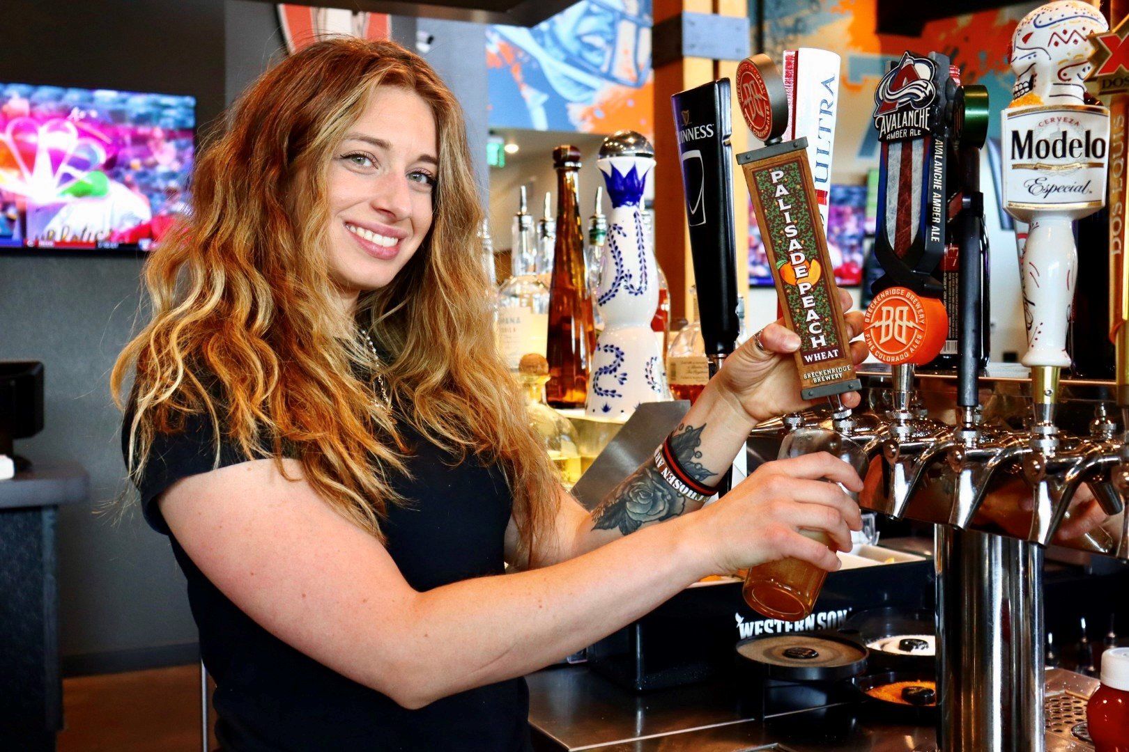 pouring beer from a tap at a bar
