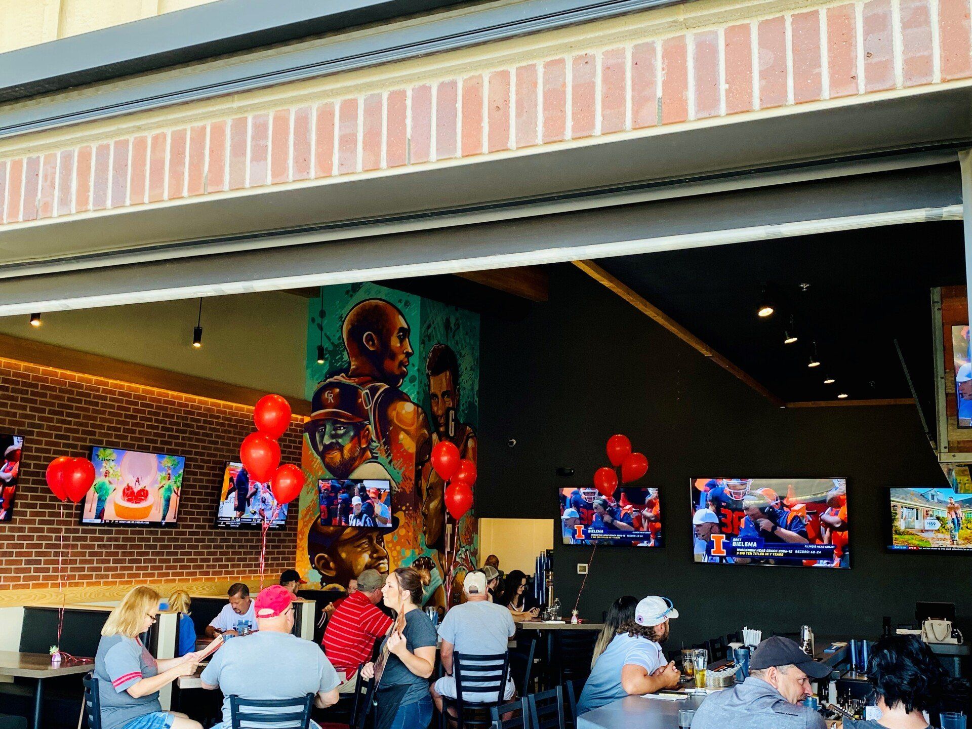 A group of people are sitting at tables in a restaurant.