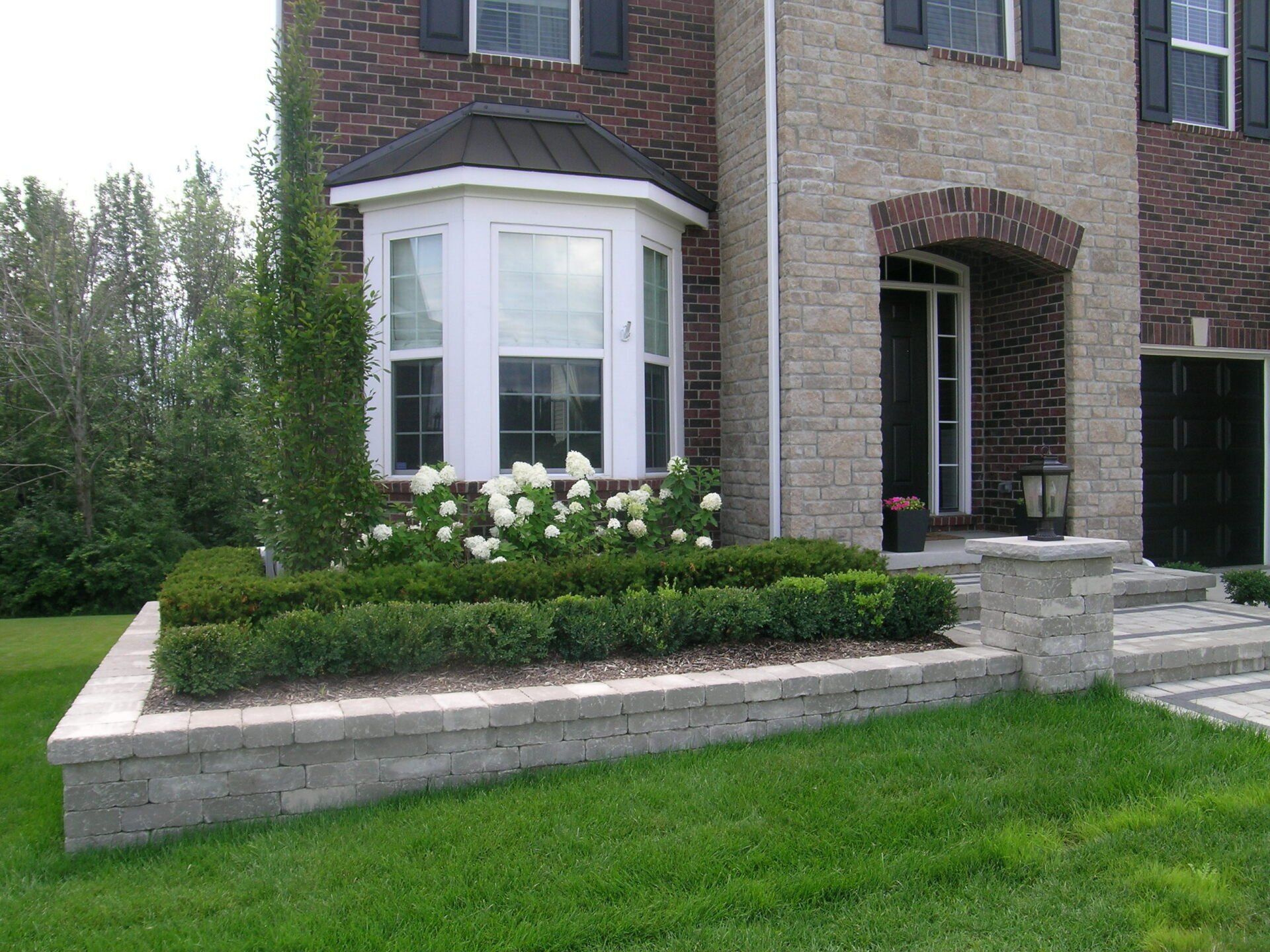 A large brick house with a large bay window