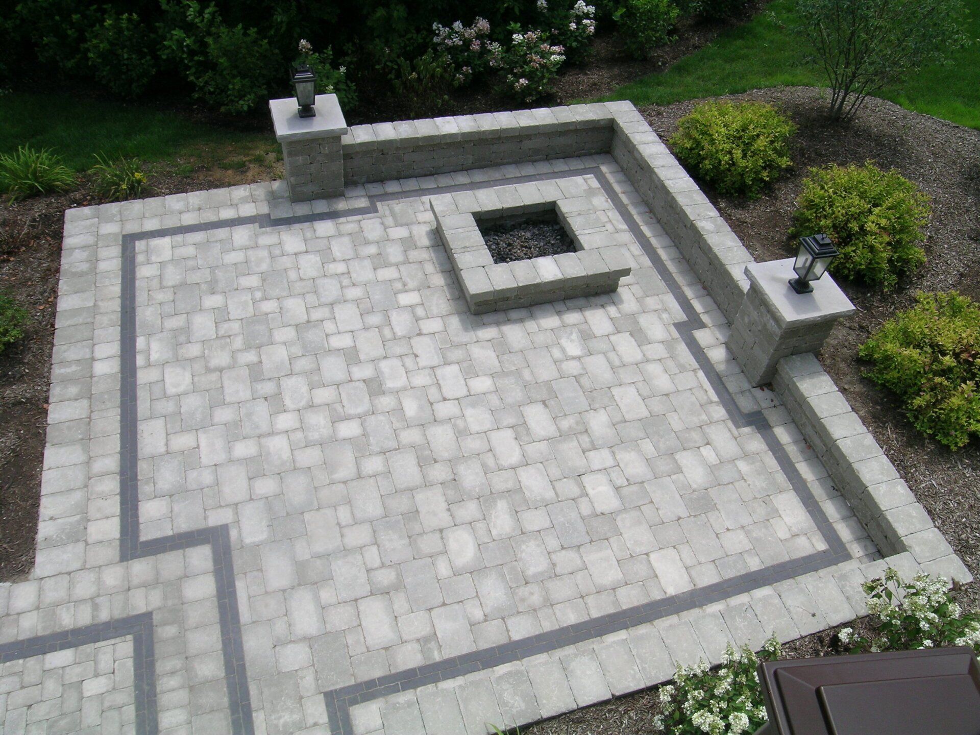 A patio with a fire pit in the middle of it