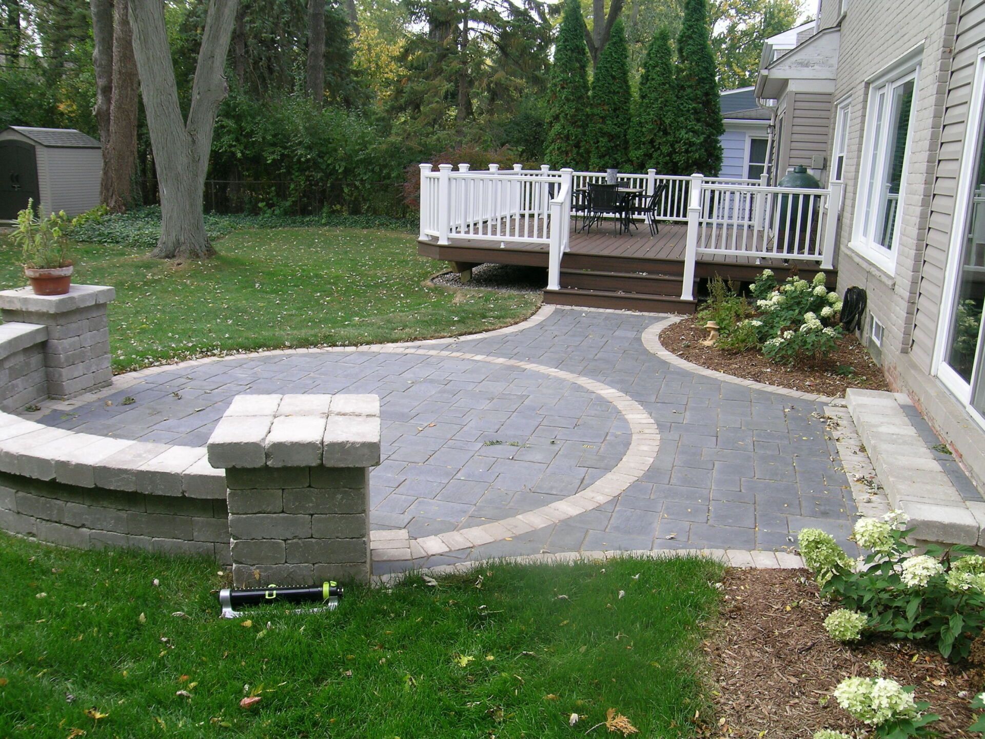 A house with a patio and a deck in the backyard