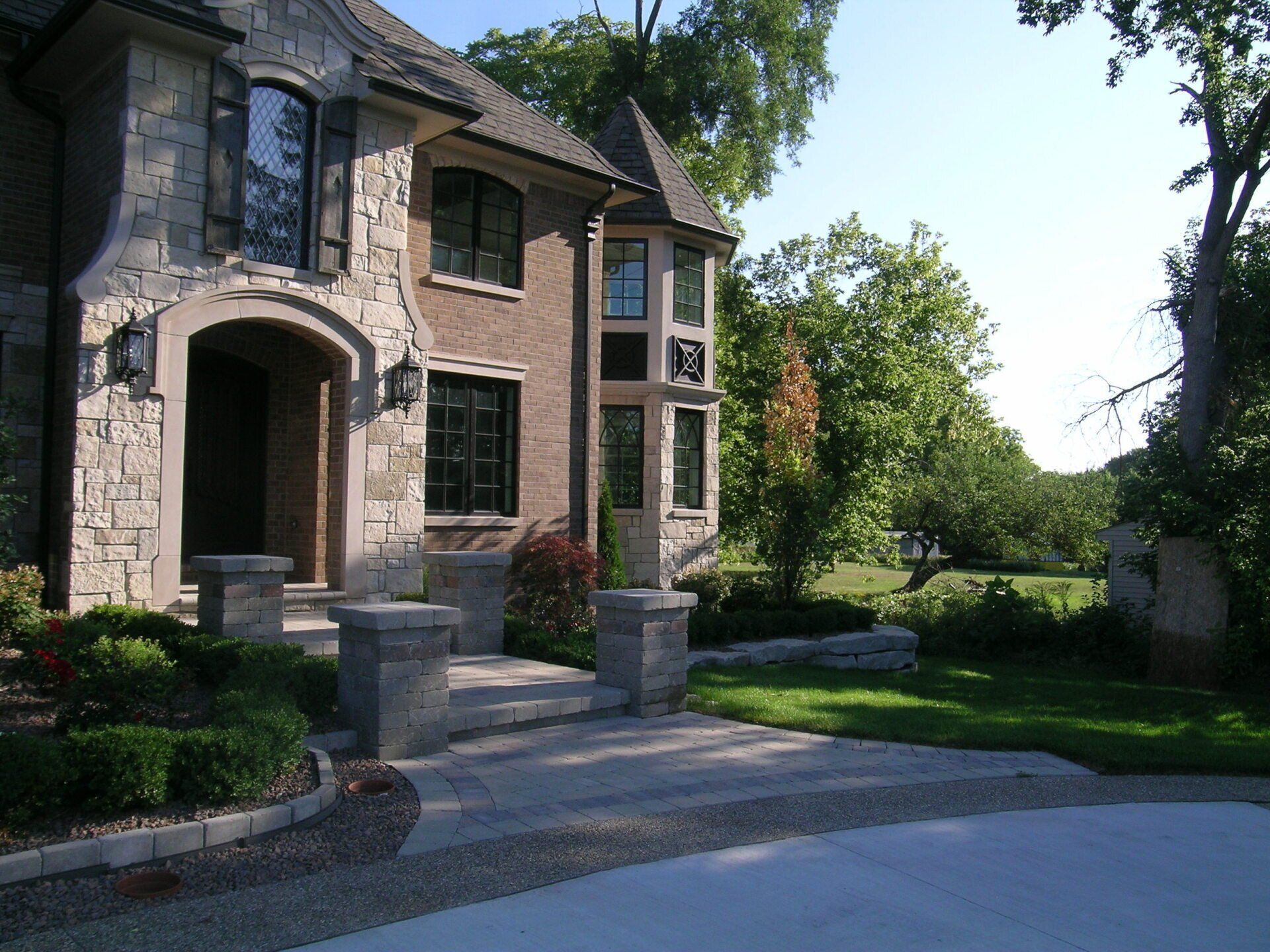 A large brick house with a driveway leading to it