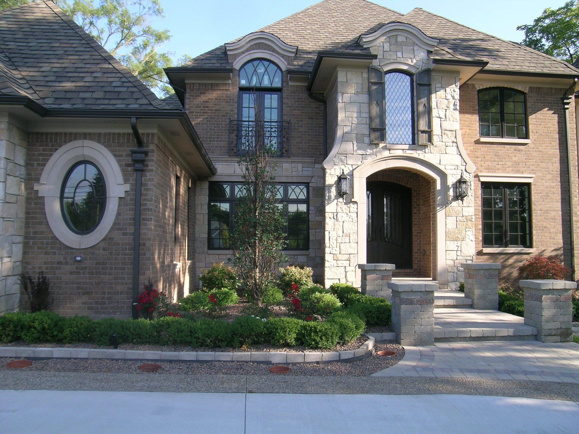 A large brick house with a circular window on the front