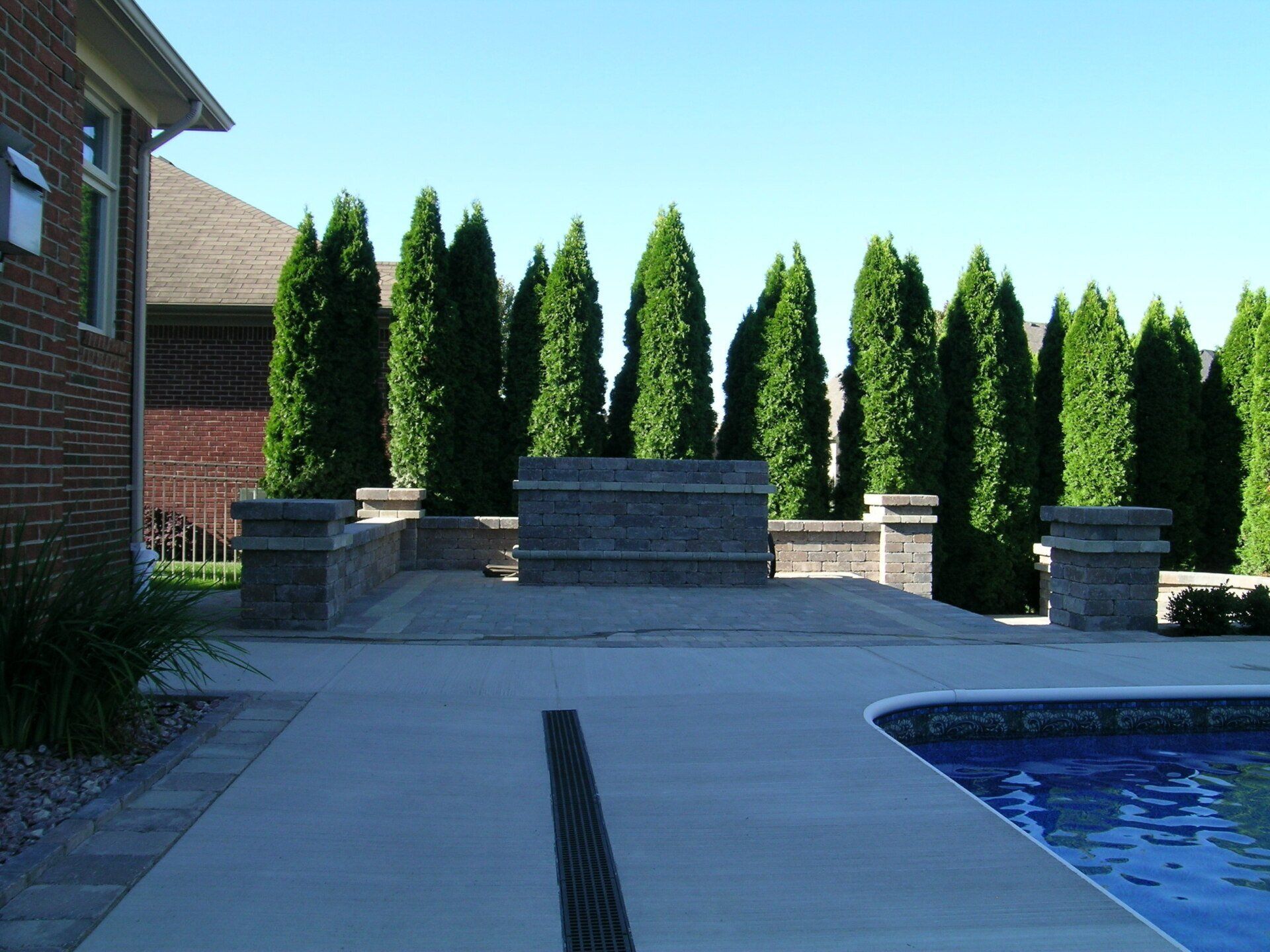 A brick house with a swimming pool in front of it