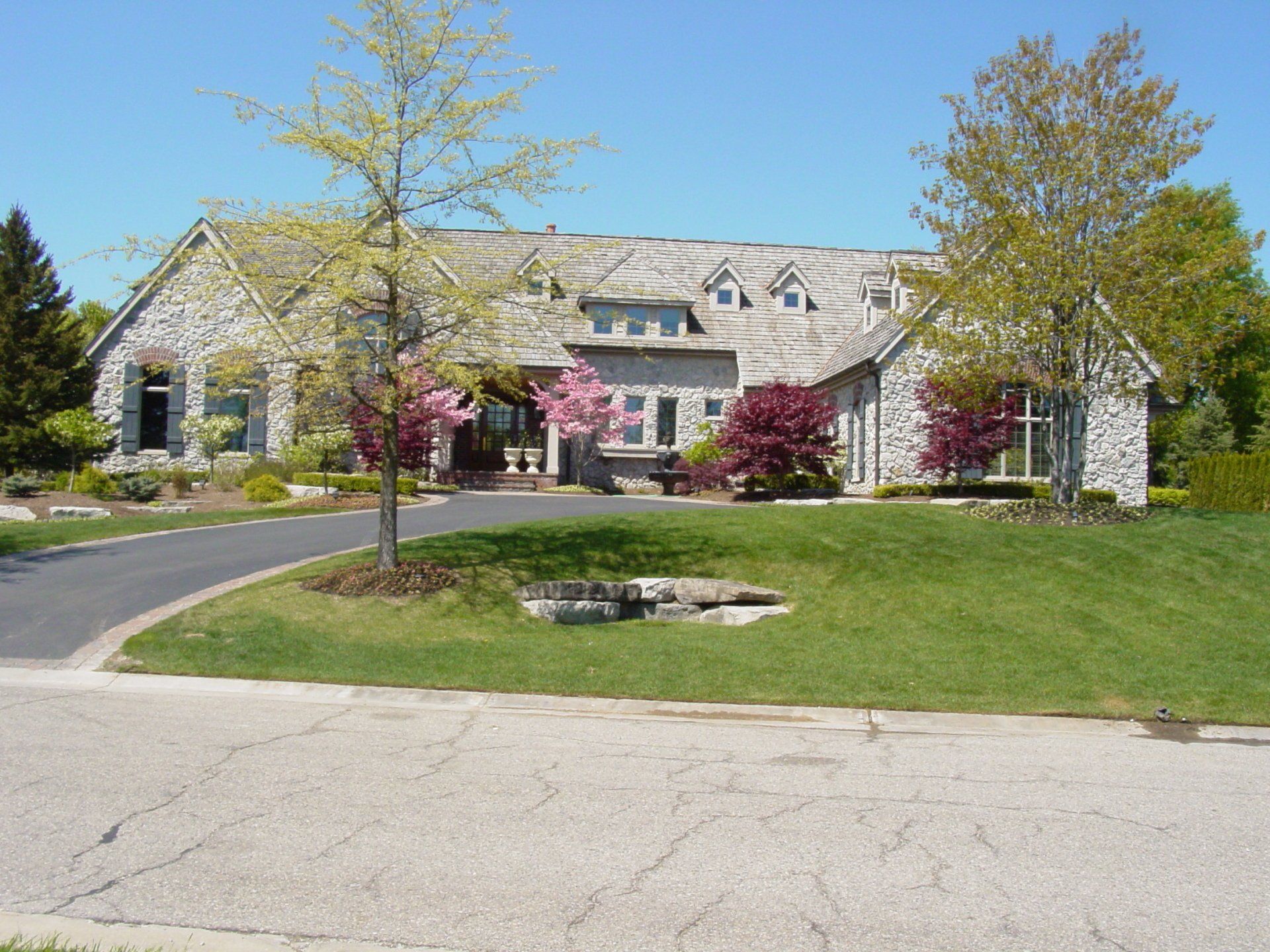A large house with a tree in front of it