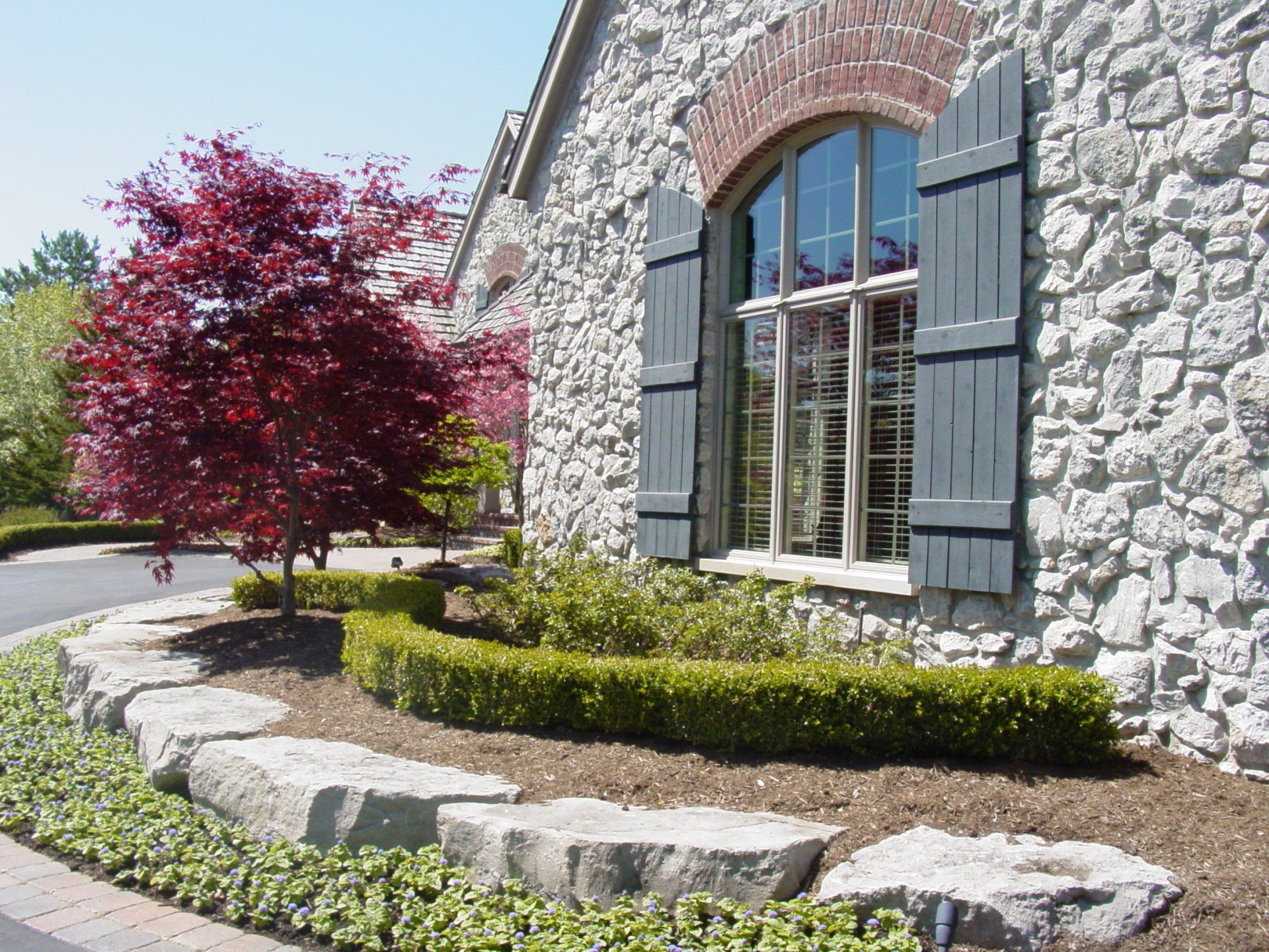 A stone building with a tree in front of it