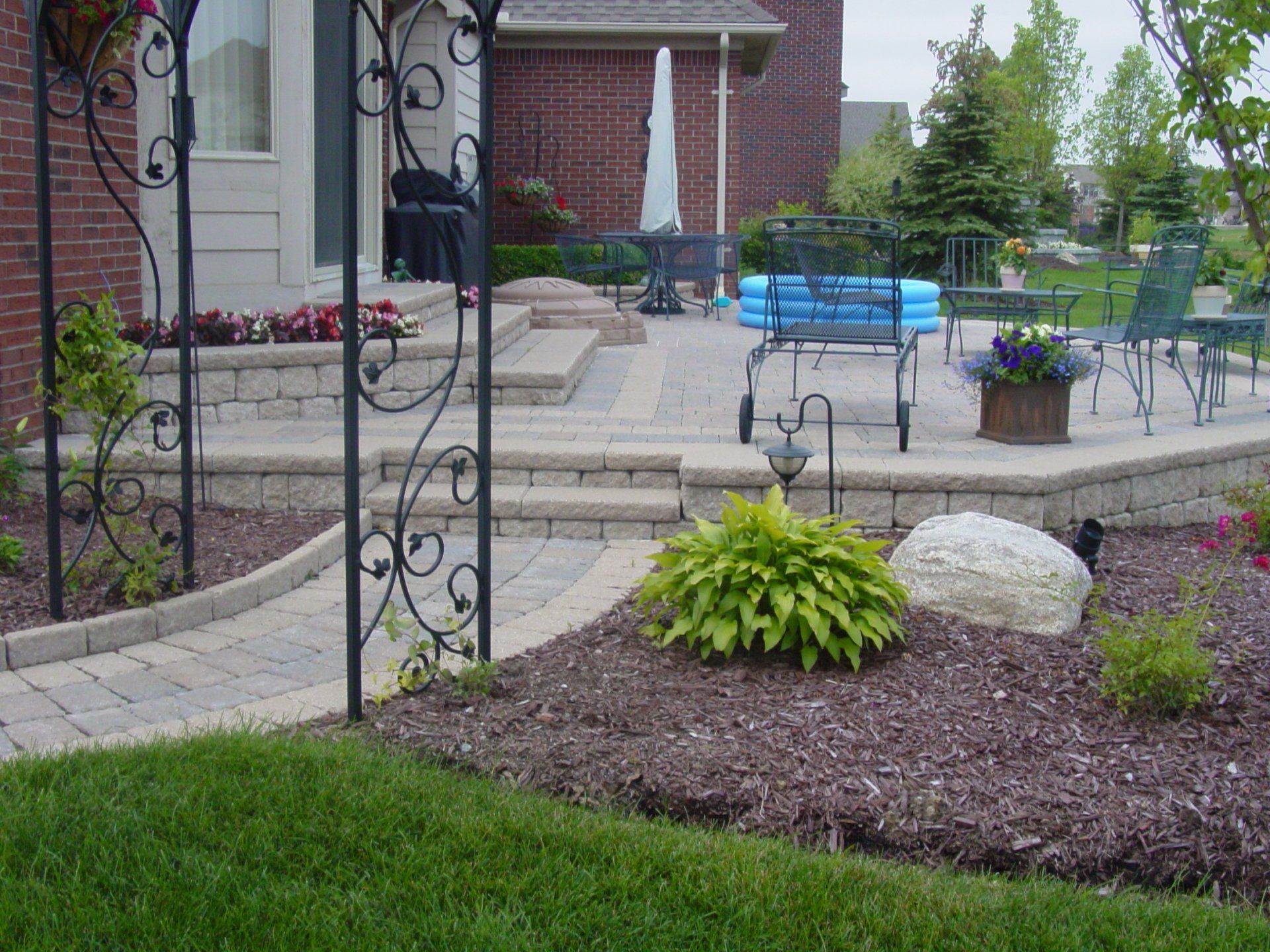 A brick house with a patio and a blue bench