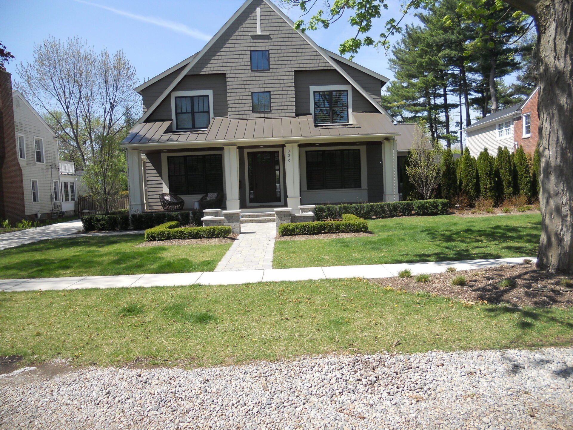 A large house with a lush green lawn in front of it
