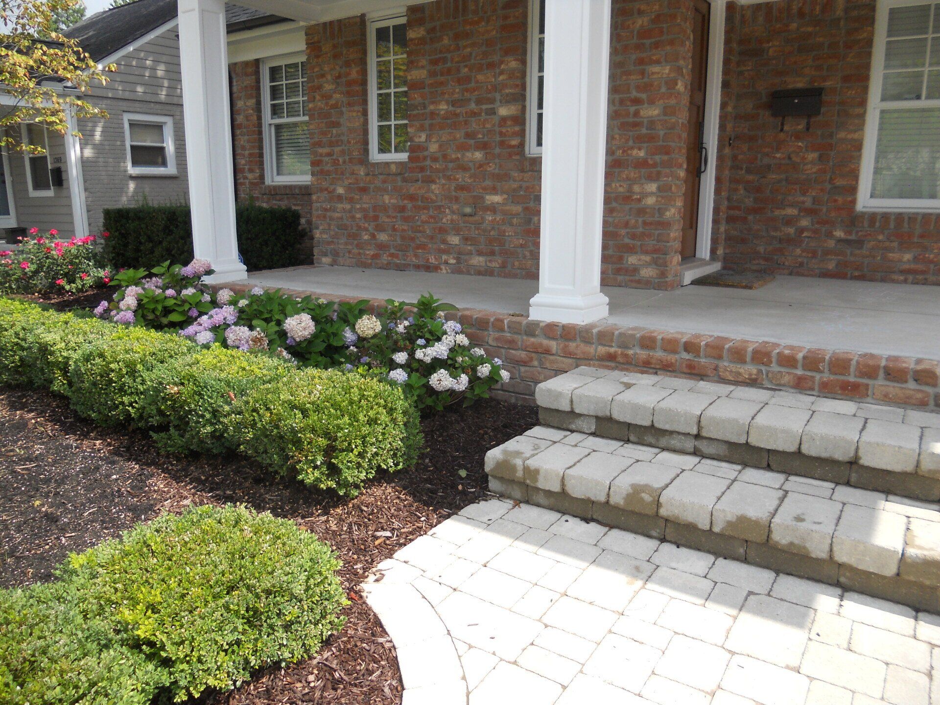 A brick house with a porch and steps