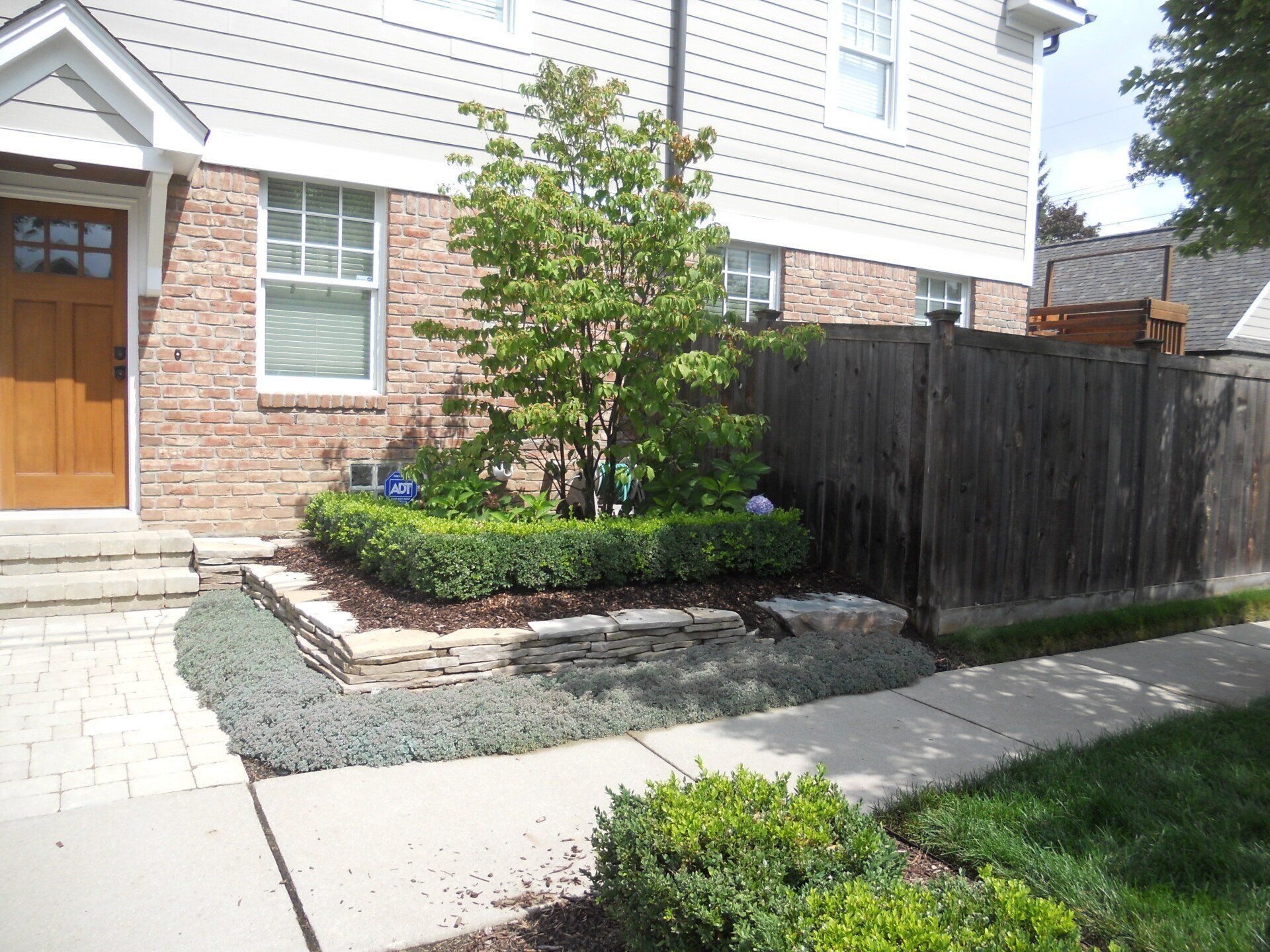 A brick house with a wooden fence in front of it