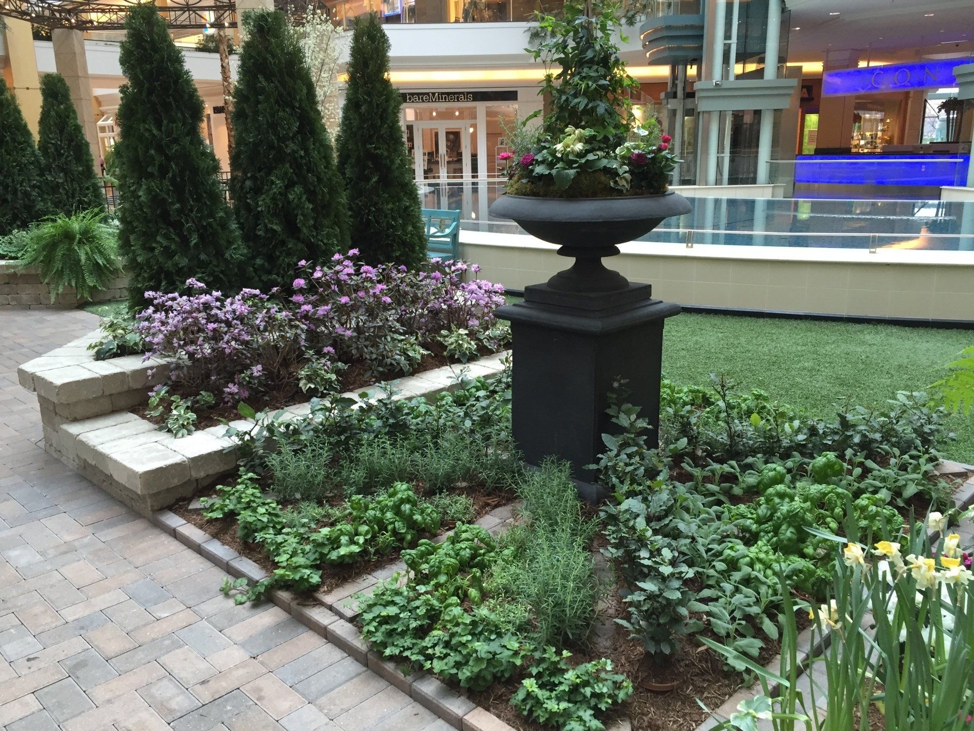 A garden with flowers and trees in a mall