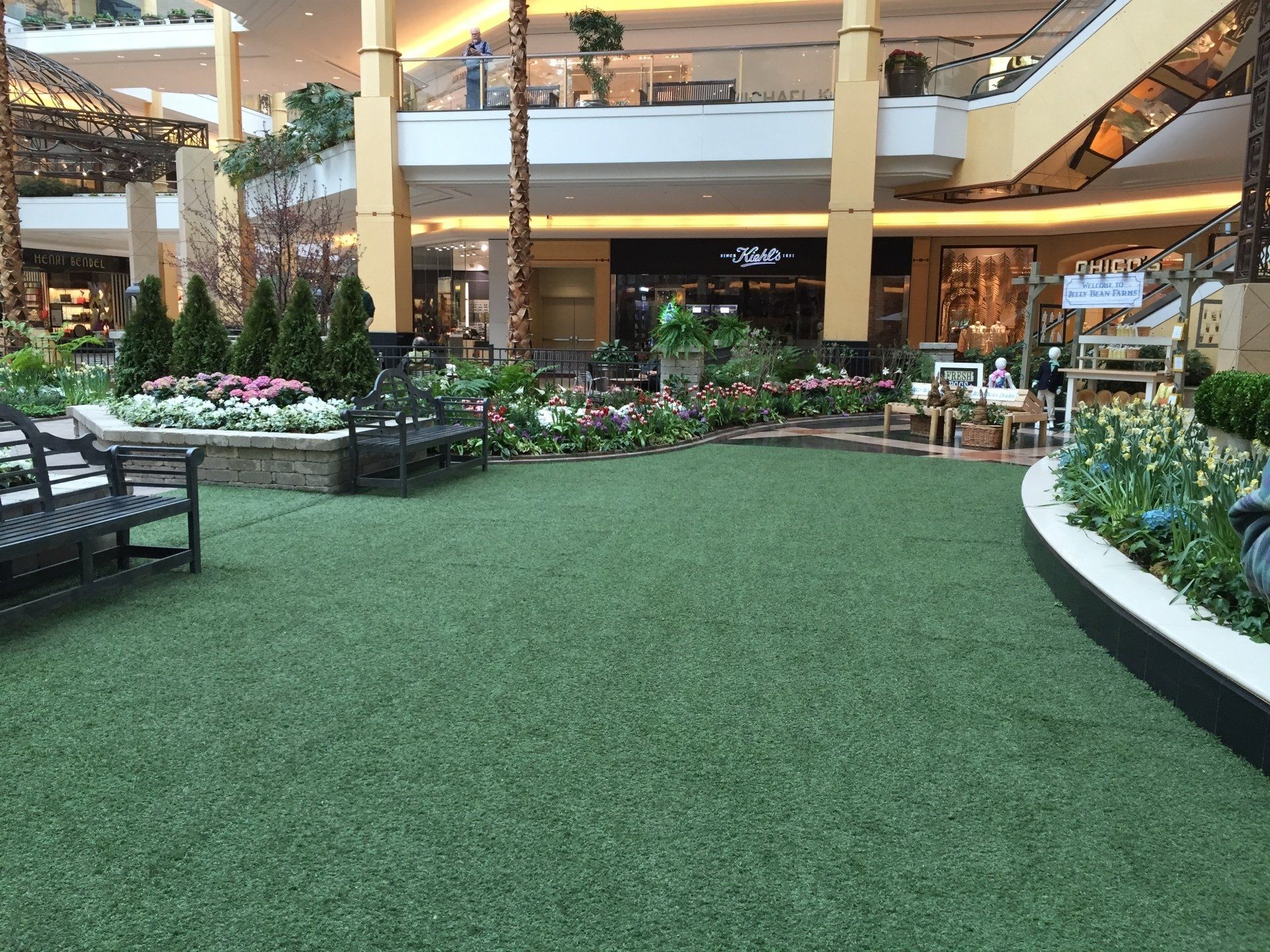 A large mall with a lot of grass and flowers