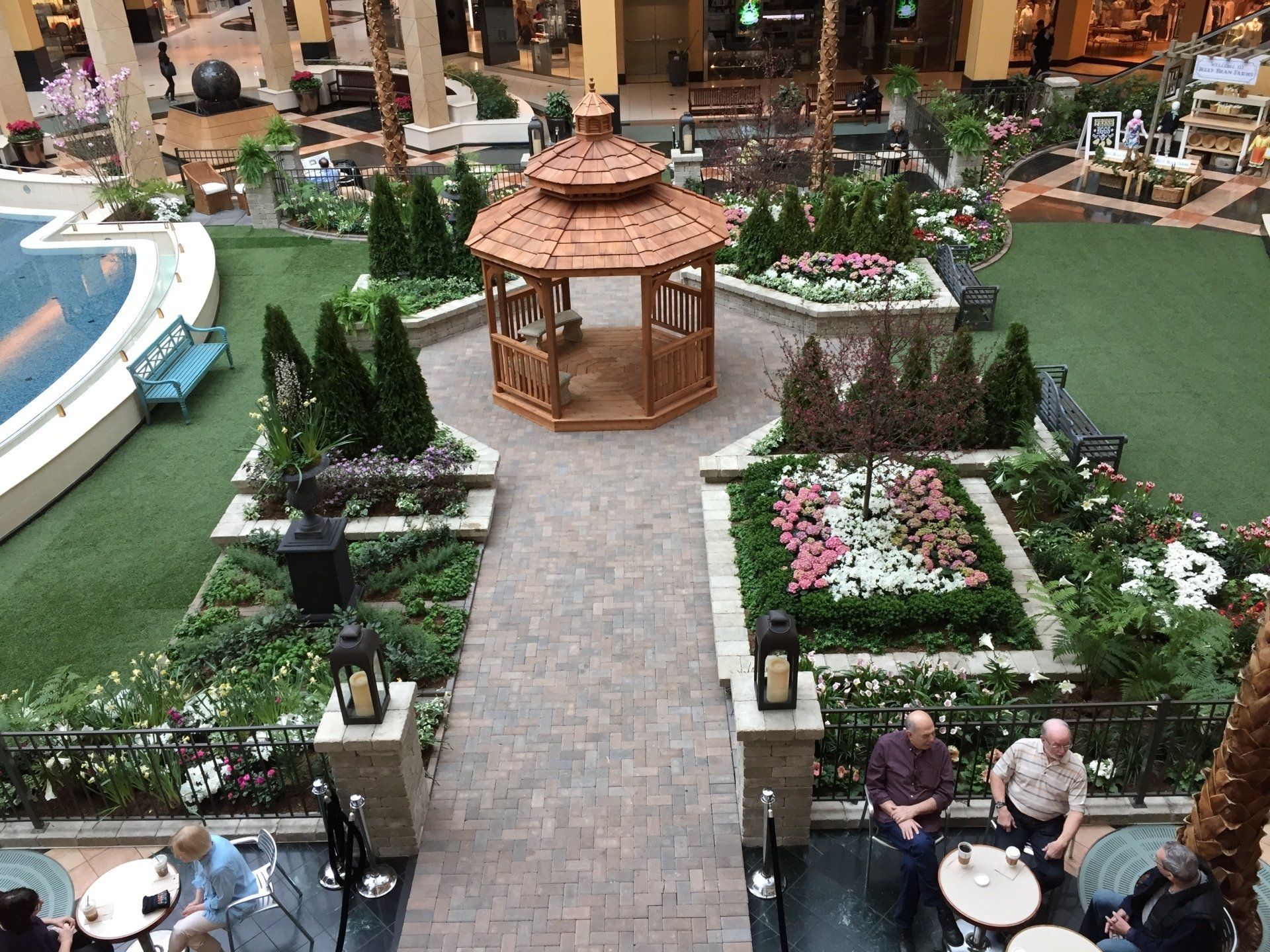 An aerial view of a garden with a gazebo in the middle