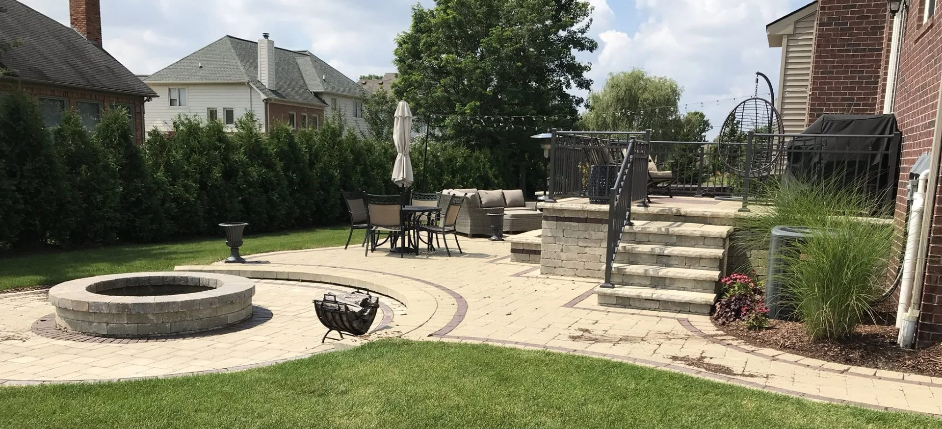 There is a fire pit in the middle of the backyard.