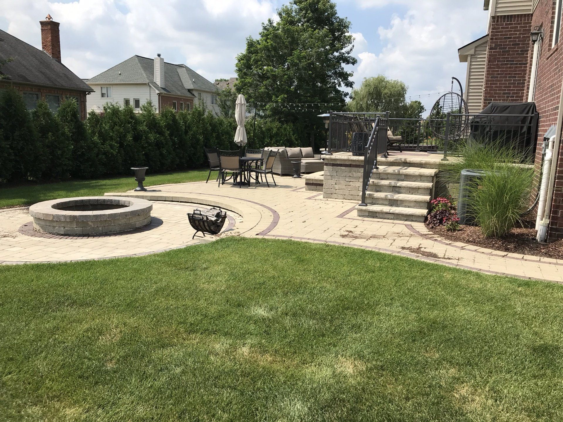 There is a fire pit in the middle of the backyard.