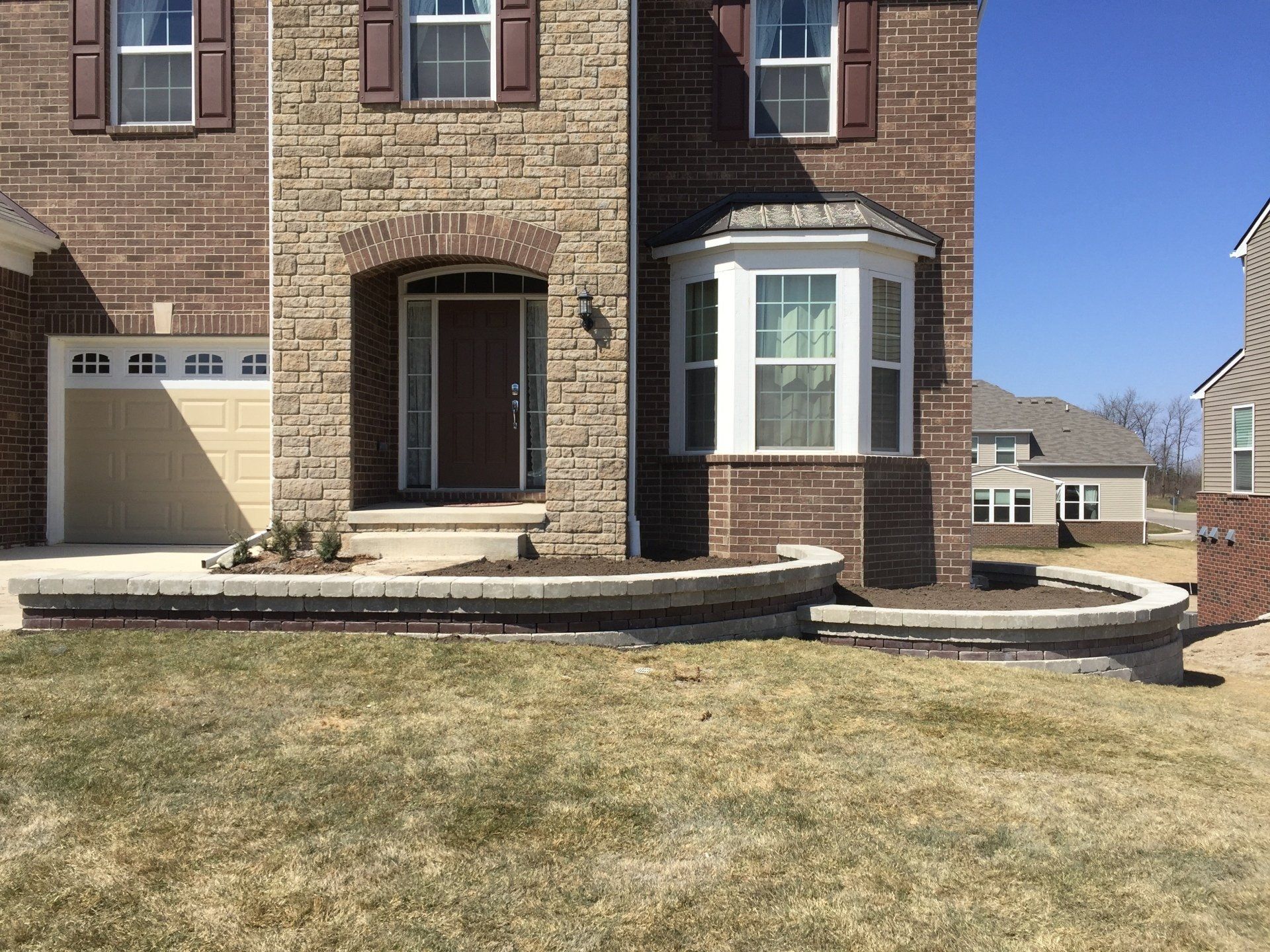 A large brick house with a large bay window