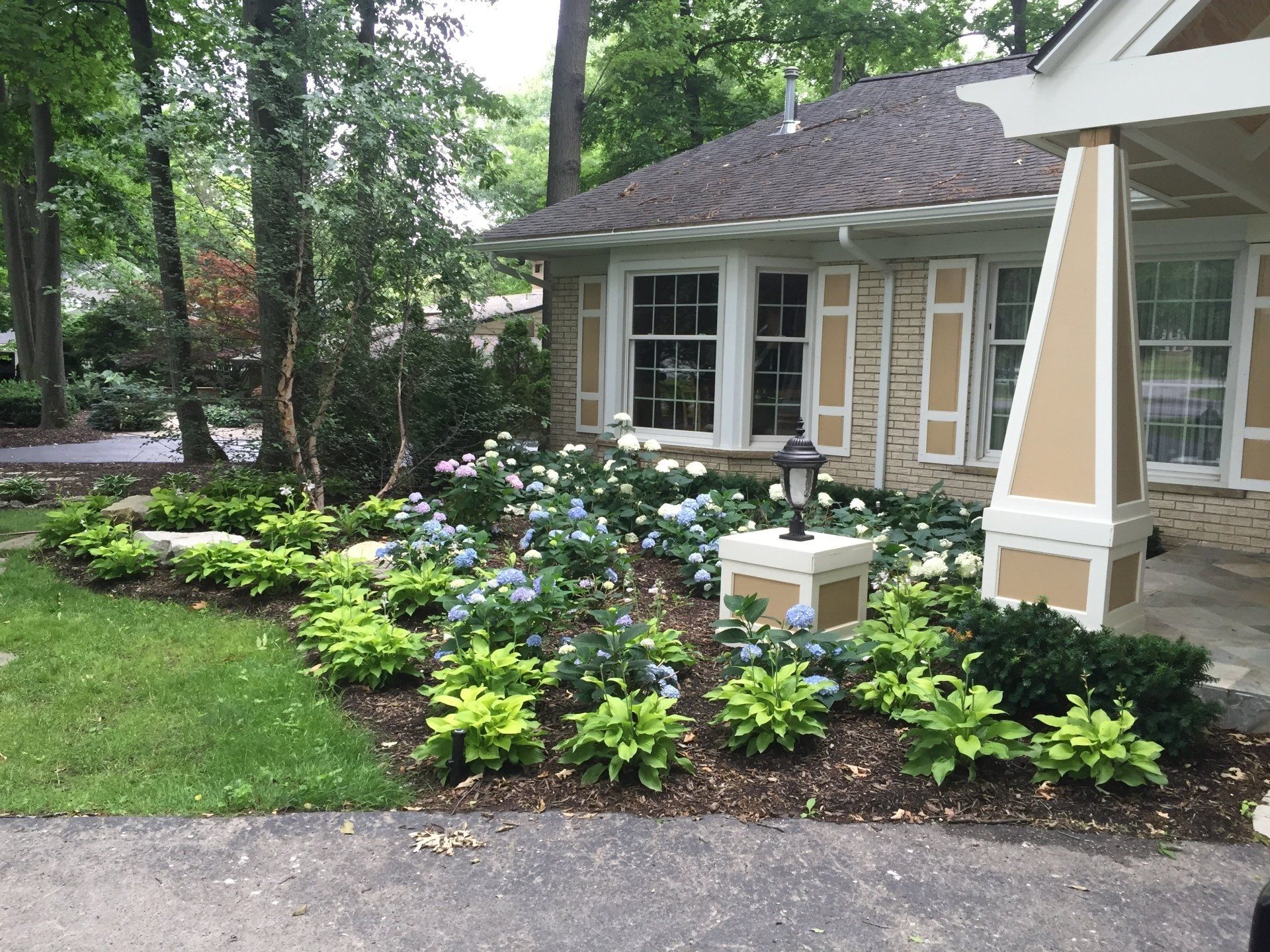 A house with a lot of flowers in front of it