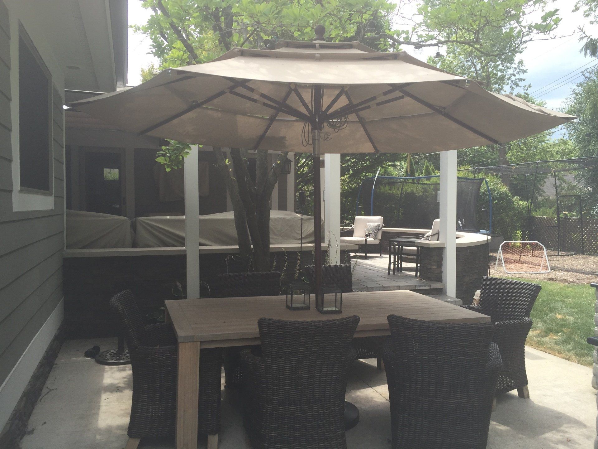 A patio with a table and chairs under an umbrella