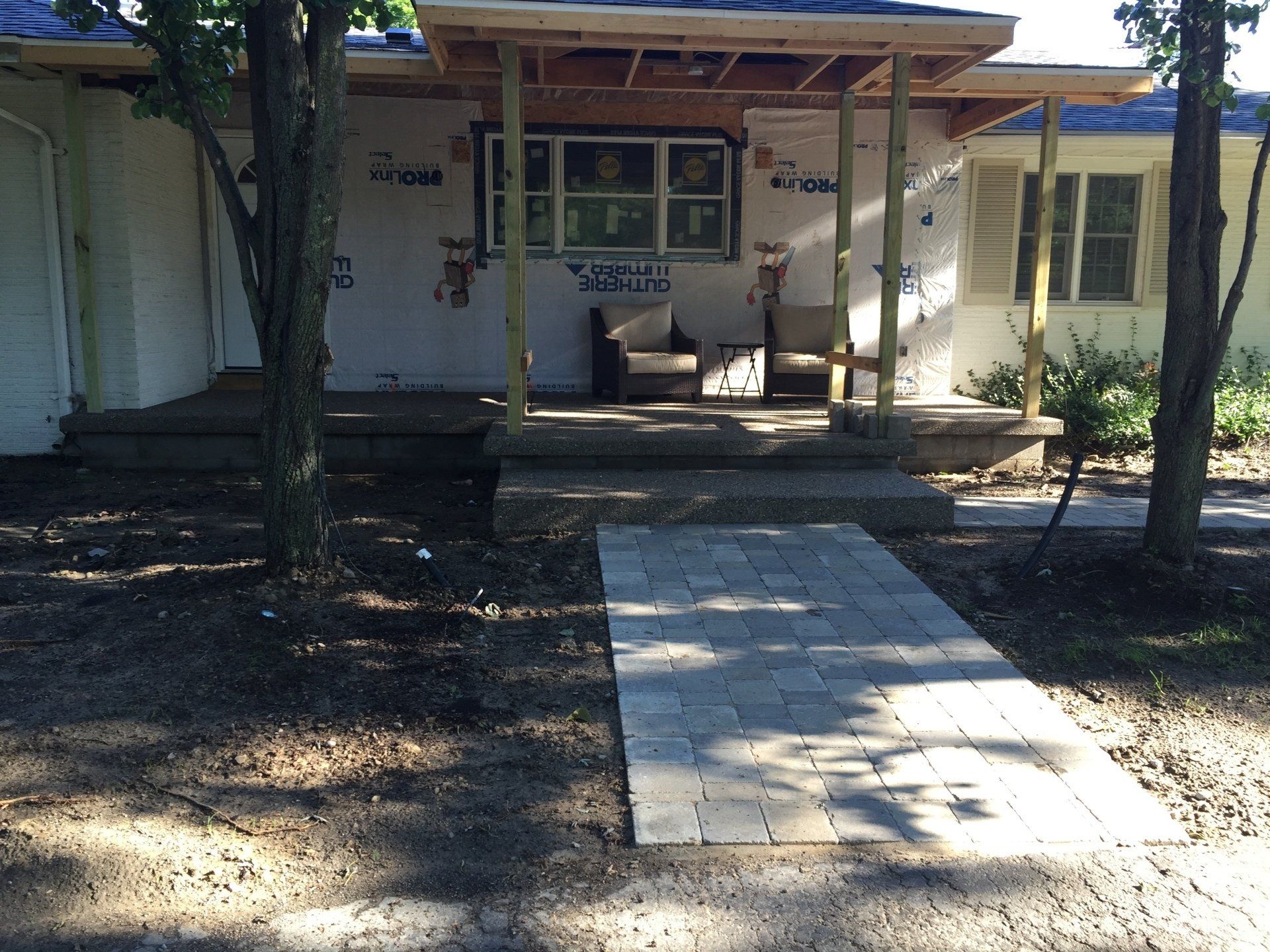 A house with a porch and a walkway leading to it