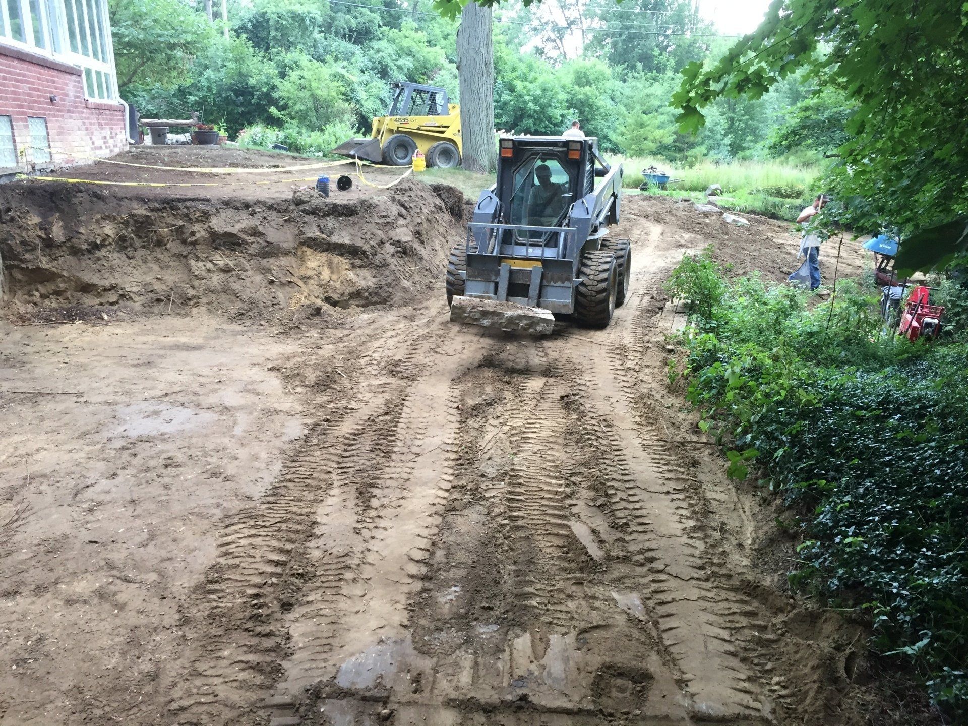 A bulldozer is moving dirt on a dirt road