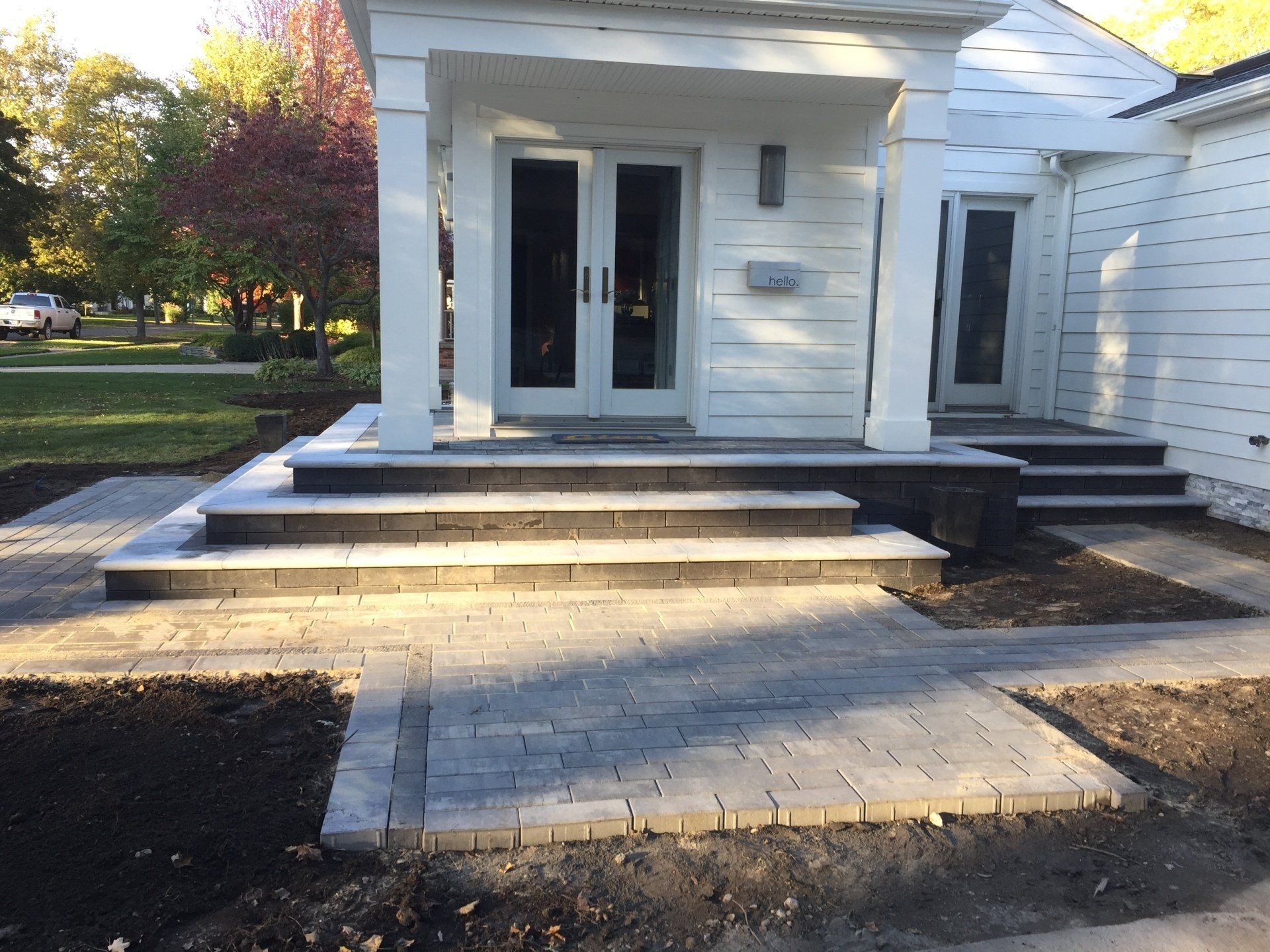 A white house with steps leading up to the front door
