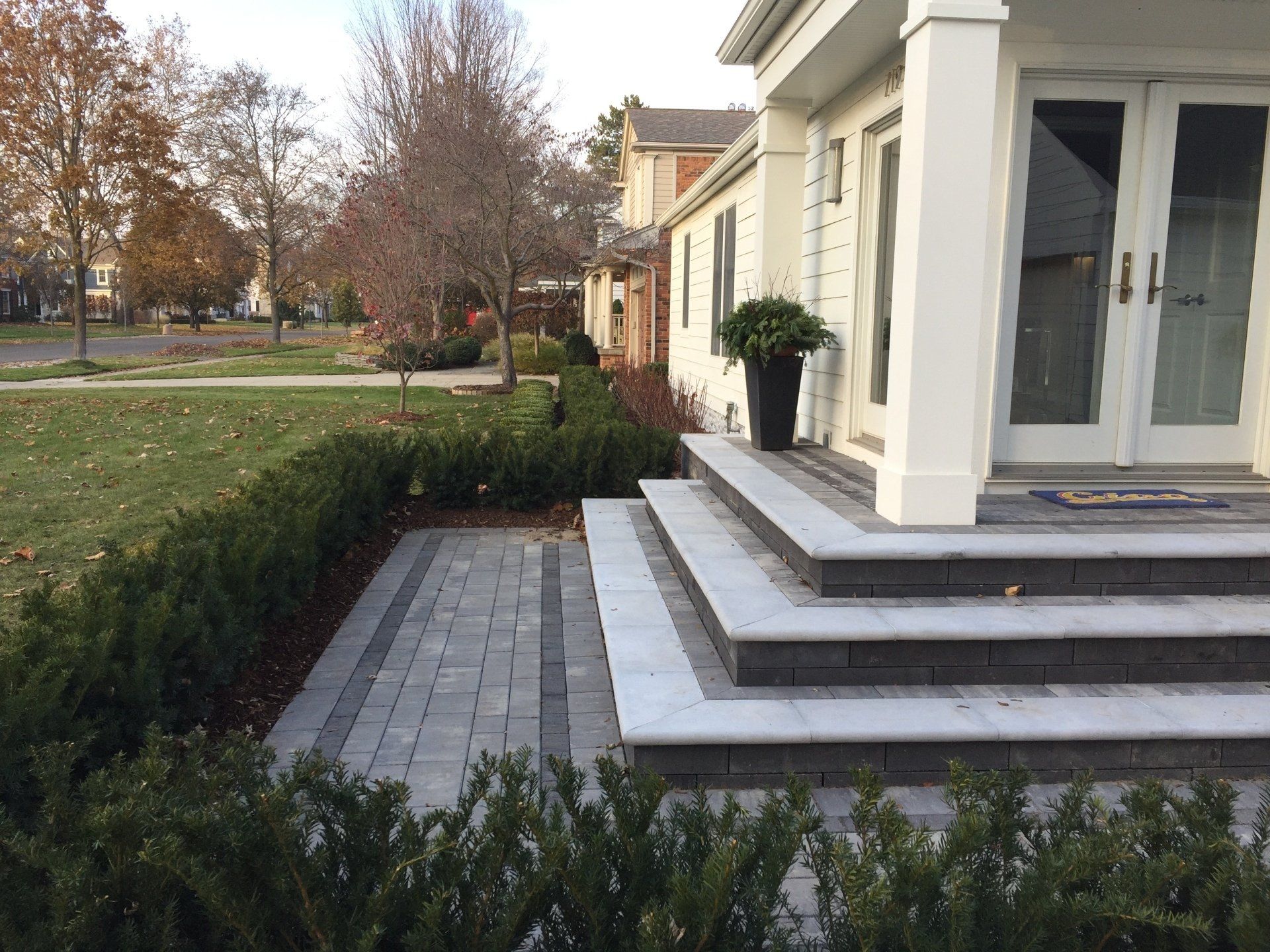 A white house with steps leading up to the front door