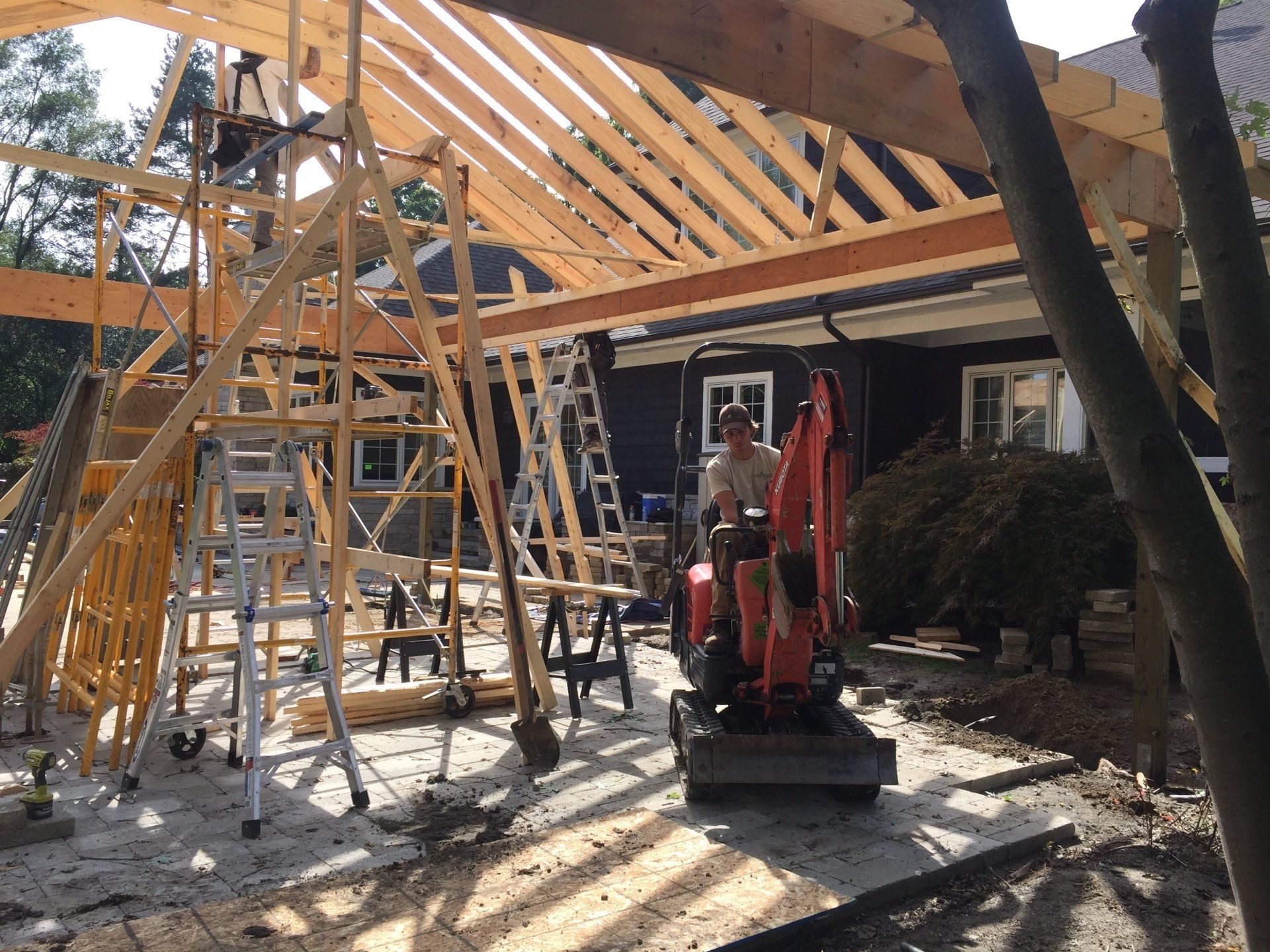 A man is standing in front of a building under construction.