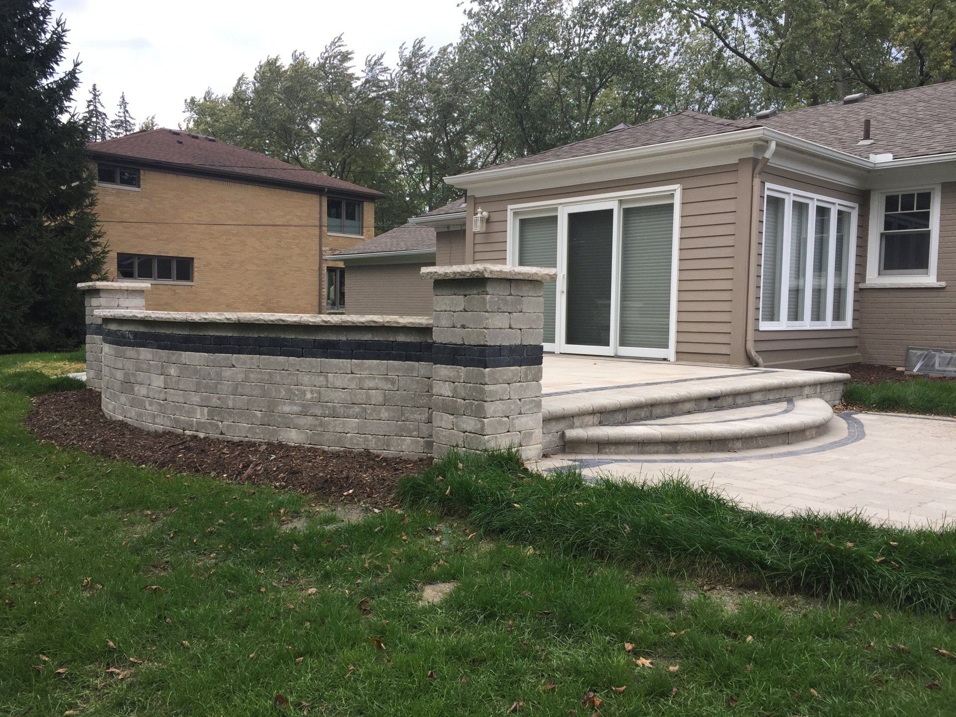 A house with a patio and stairs in front of it