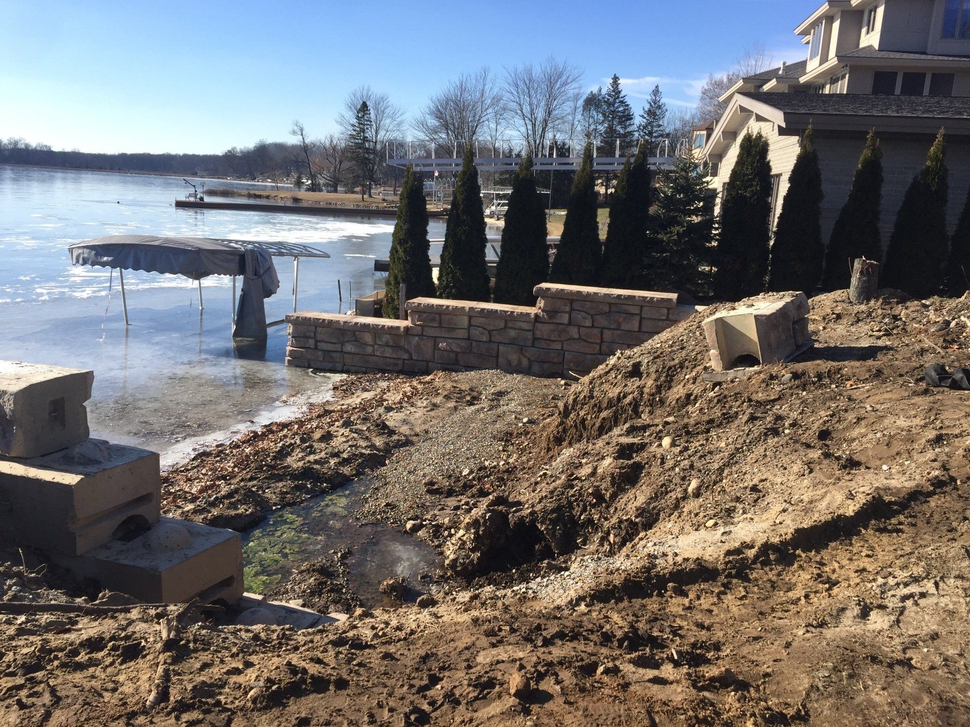 A house is being built on the shore of a lake.