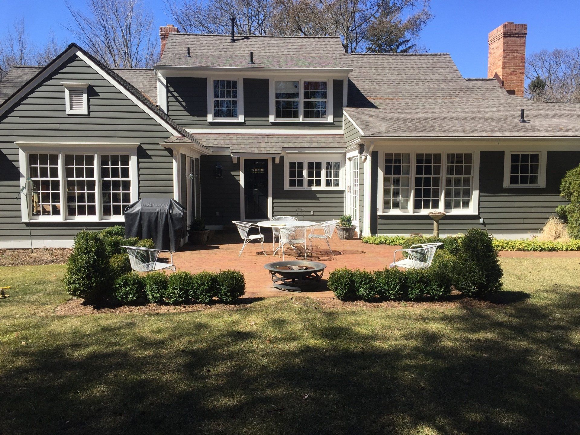 A large house with a fire pit in front of it