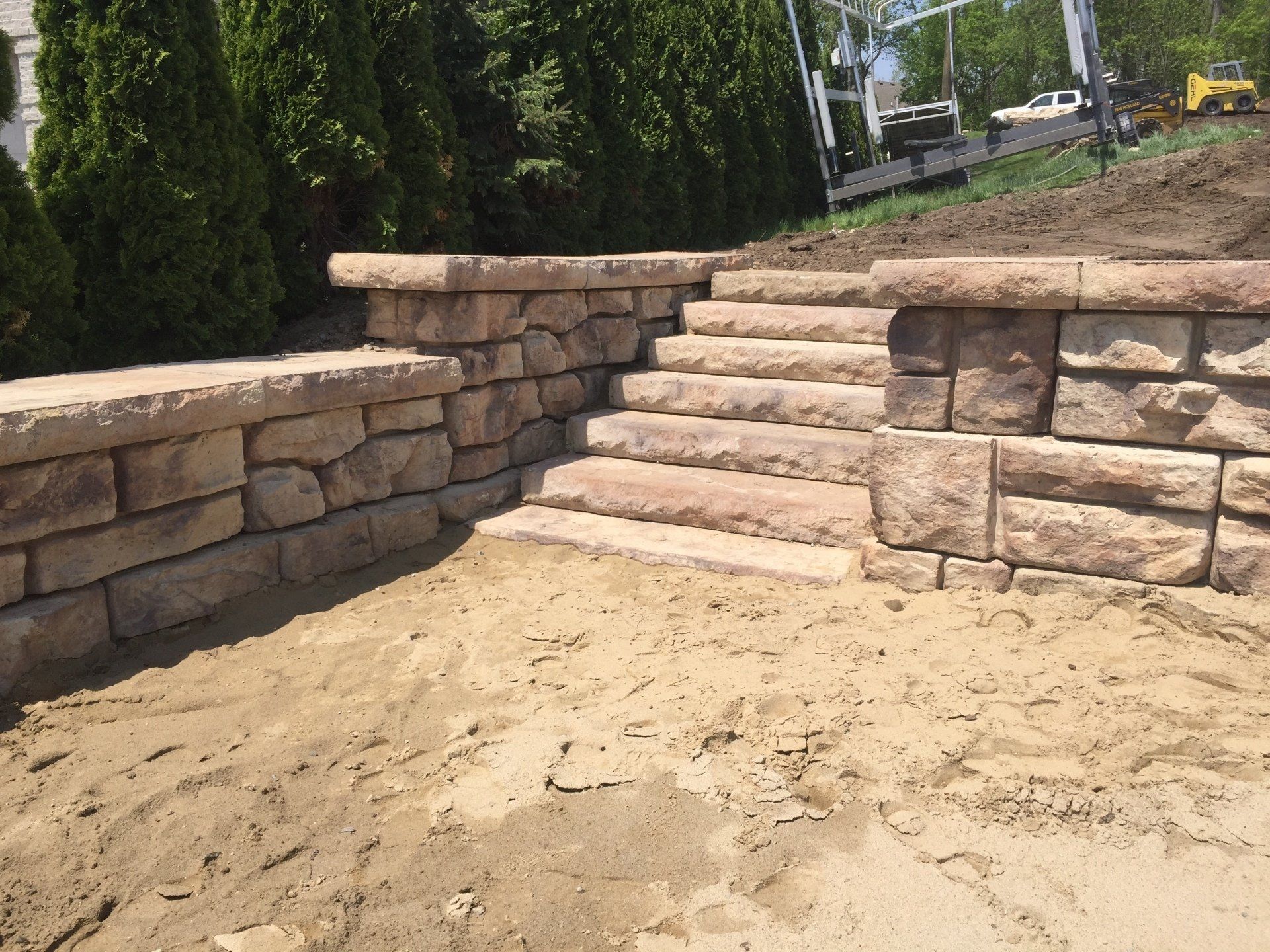A stone wall with stairs leading up to it
