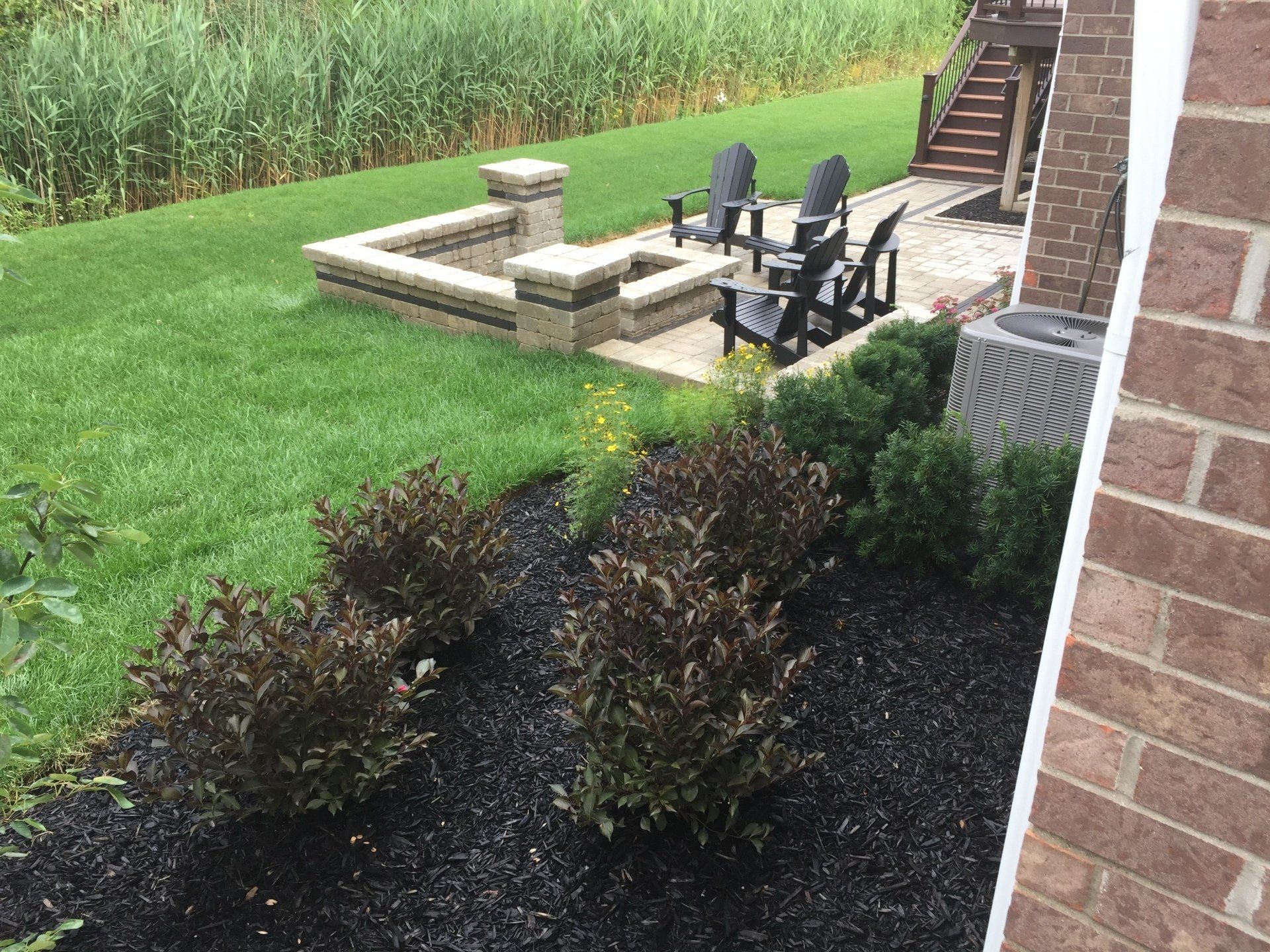 There is a fire pit in the backyard of a house.