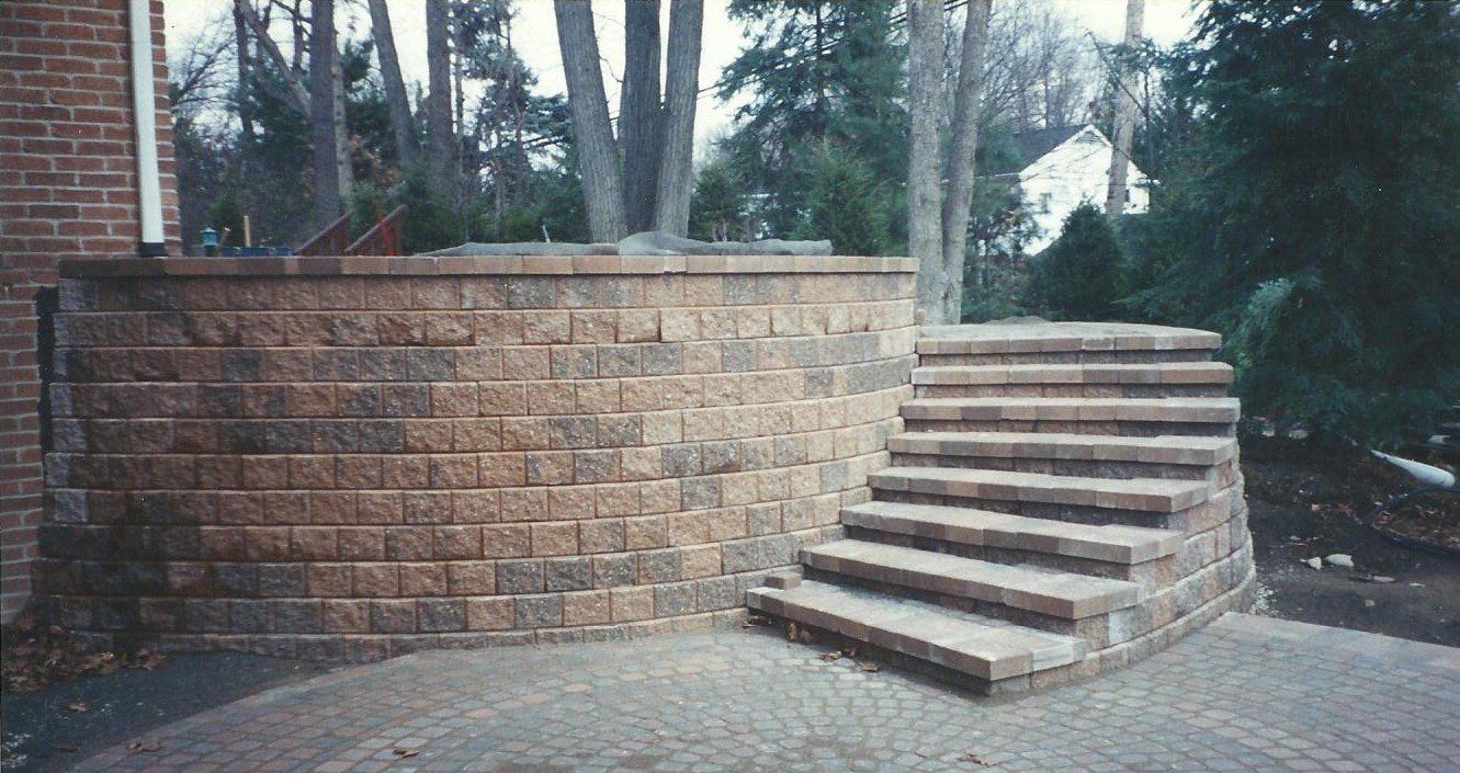 A brick wall with stairs leading up to it