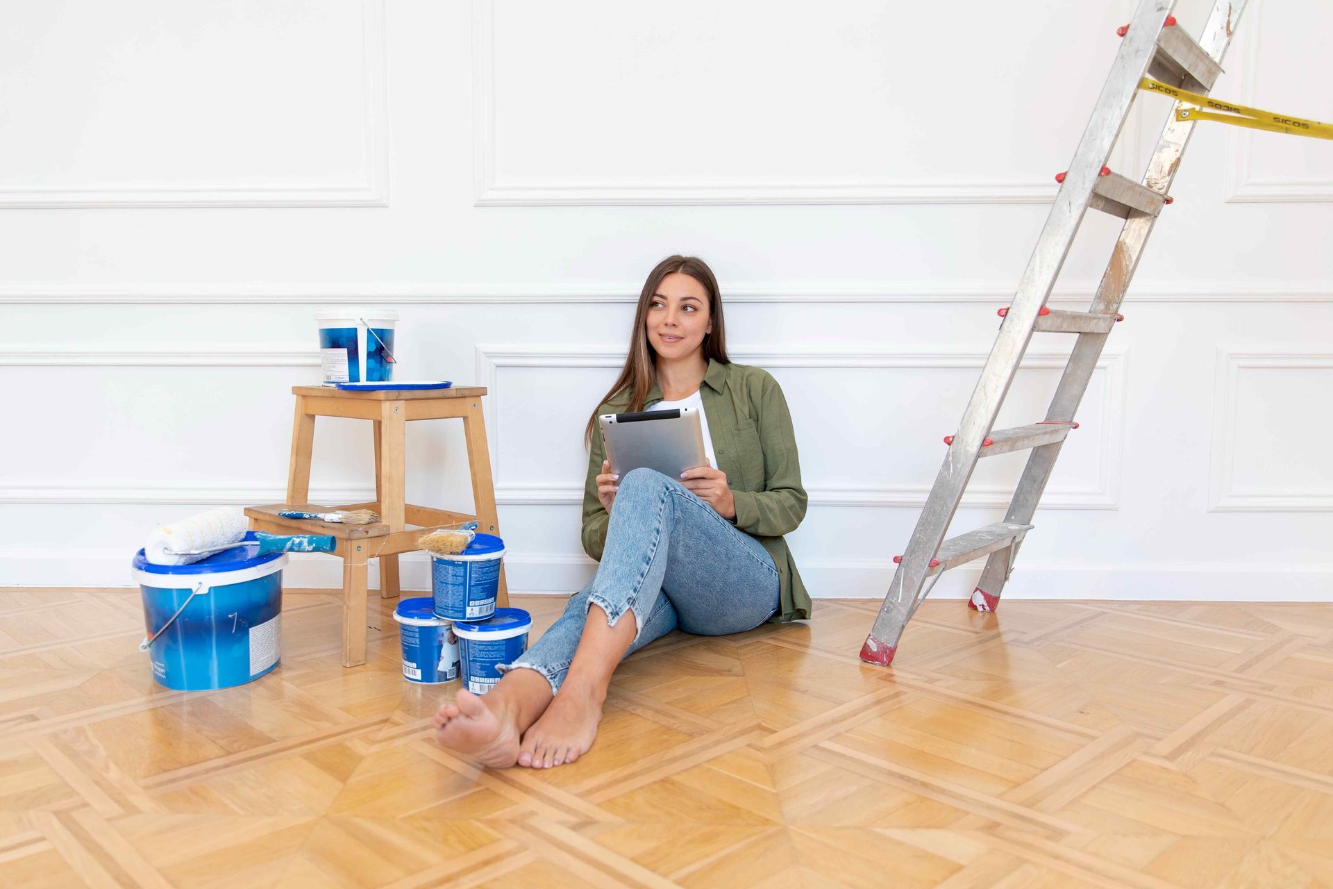 woman sitting on floor thinking of how to paint the room
