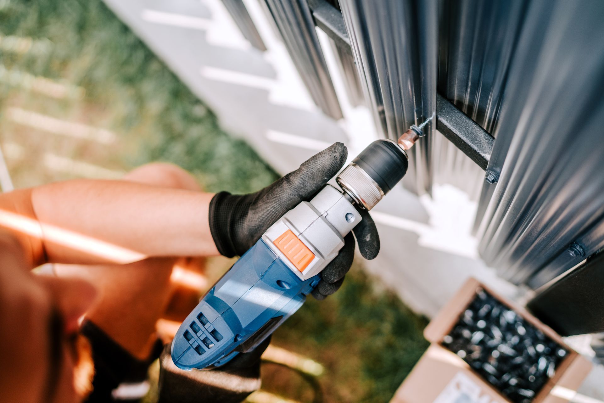 A person is using a drill to drill a hole in a wall.