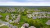 An aerial view of a residential neighborhood with lots of houses and trees.