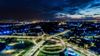 An aerial view of a city at night with a lot of traffic.