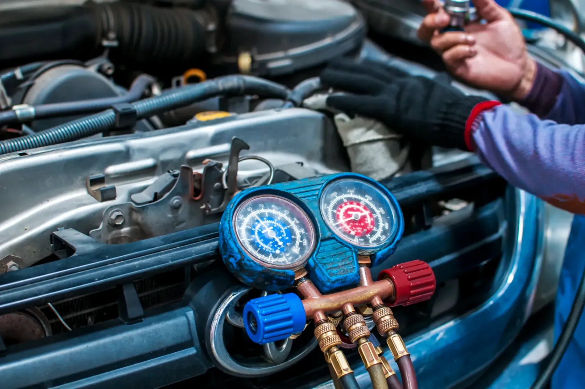 A person is working on the engine of a car.