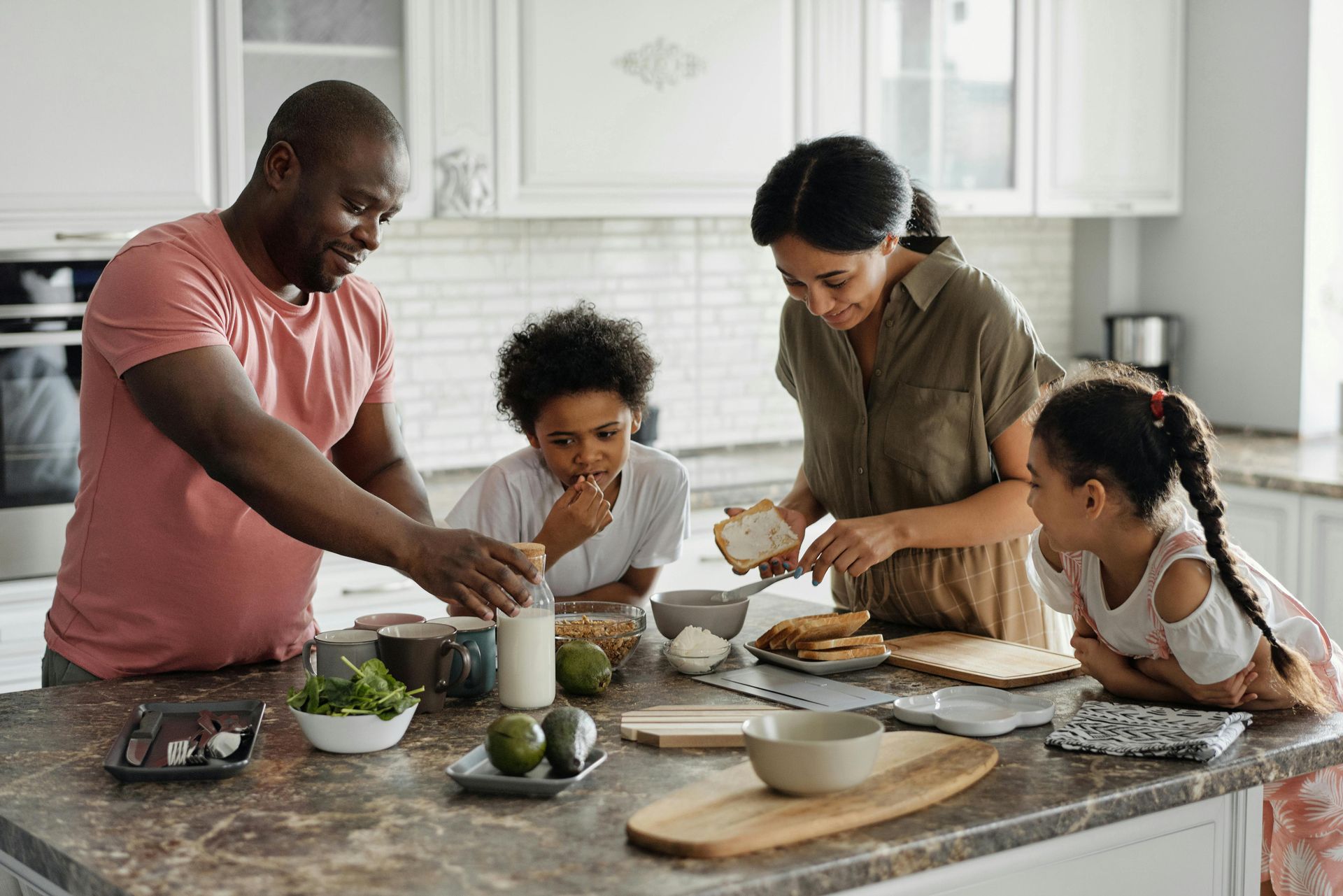 This is a picture of a family preparing a meal together. 