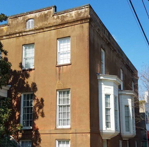 A large brown building with a lot of windows