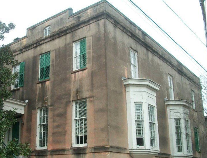 A building with a lot of windows and green shutters