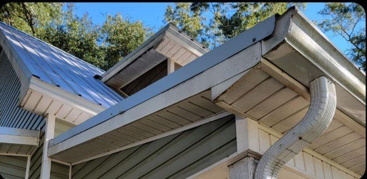 A house with a metal roof and gutters on it